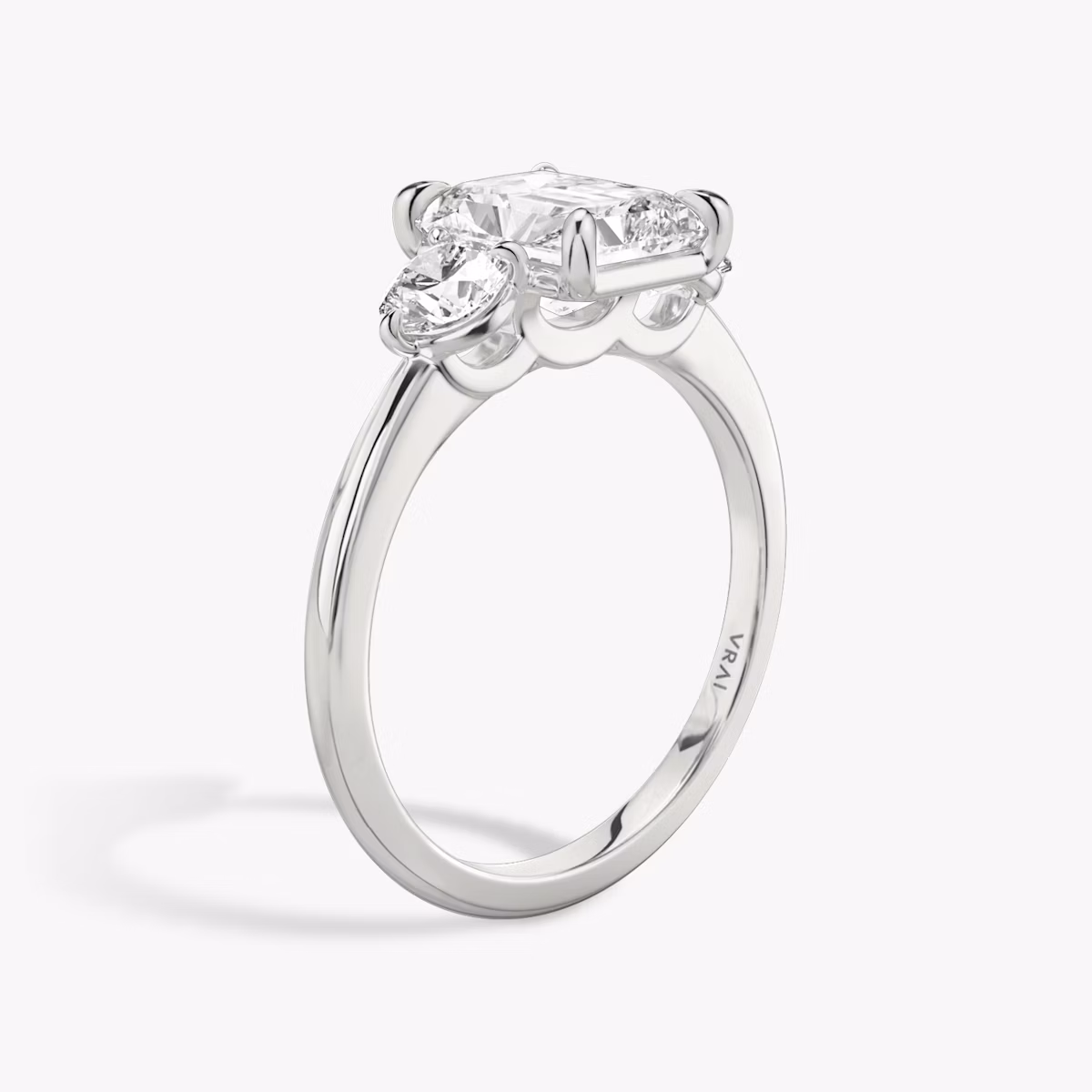 The Three Stone | Radiant | Platinum | bandAccent: Plain | sideStoneCarat: 0.25ct | sideStoneShape: Round Brilliant | diamondOrientation: vertical | caratWeight: other