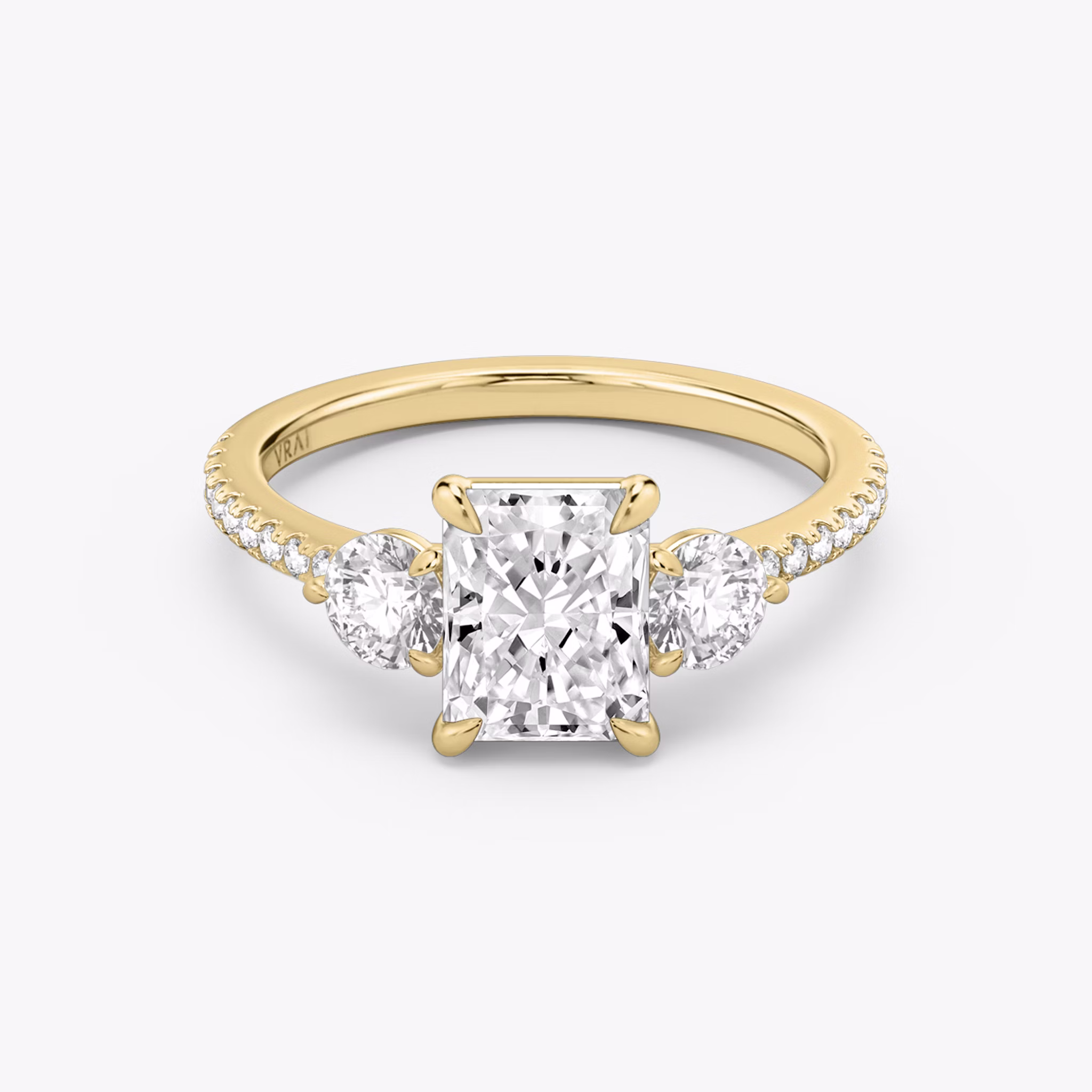 The Three Stone | Radiant | 18k | Yellow Gold | bandAccent: Pavé | sideStoneCarat: 0.25ct | sideStoneShape: Round Brilliant | diamondOrientation: vertical | caratWeight: other