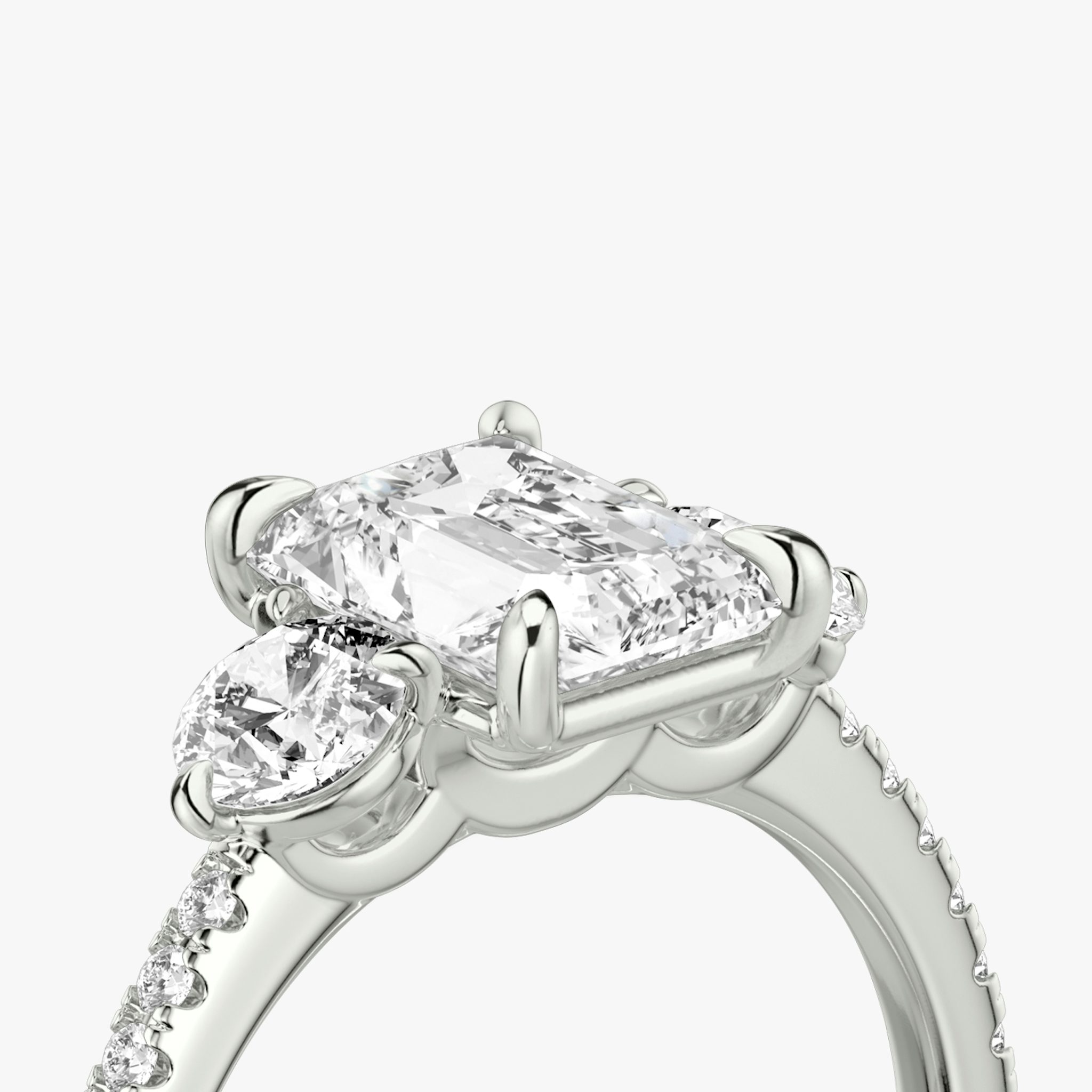 The Three Stone | Radiant | 18k | White Gold | bandAccent: Pavé | sideStoneCarat: 0.25ct | sideStoneShape: Round Brilliant | diamondOrientation: vertical | caratWeight: other