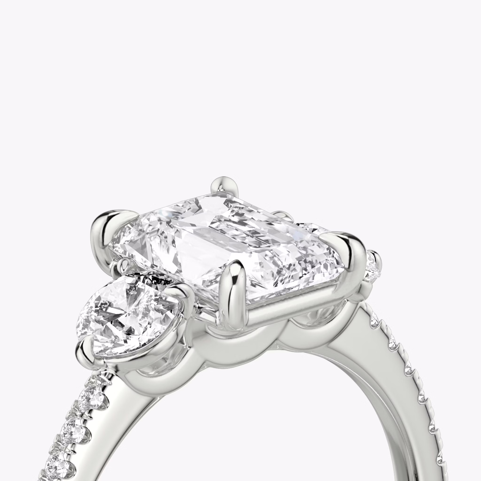 The Three Stone | Radiant | Platinum | bandAccent: Pavé | sideStoneCarat: 0.25ct | sideStoneShape: Round Brilliant | diamondOrientation: vertical | caratWeight: other
