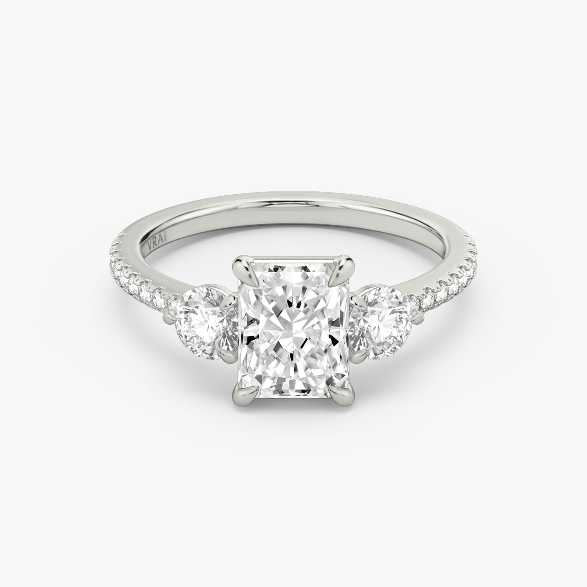 The Three Stone | Radiant | Platinum | bandAccent: Pavé | sideStoneCarat: 0.25ct | sideStoneShape: Round Brilliant | diamondOrientation: vertical | caratWeight: other