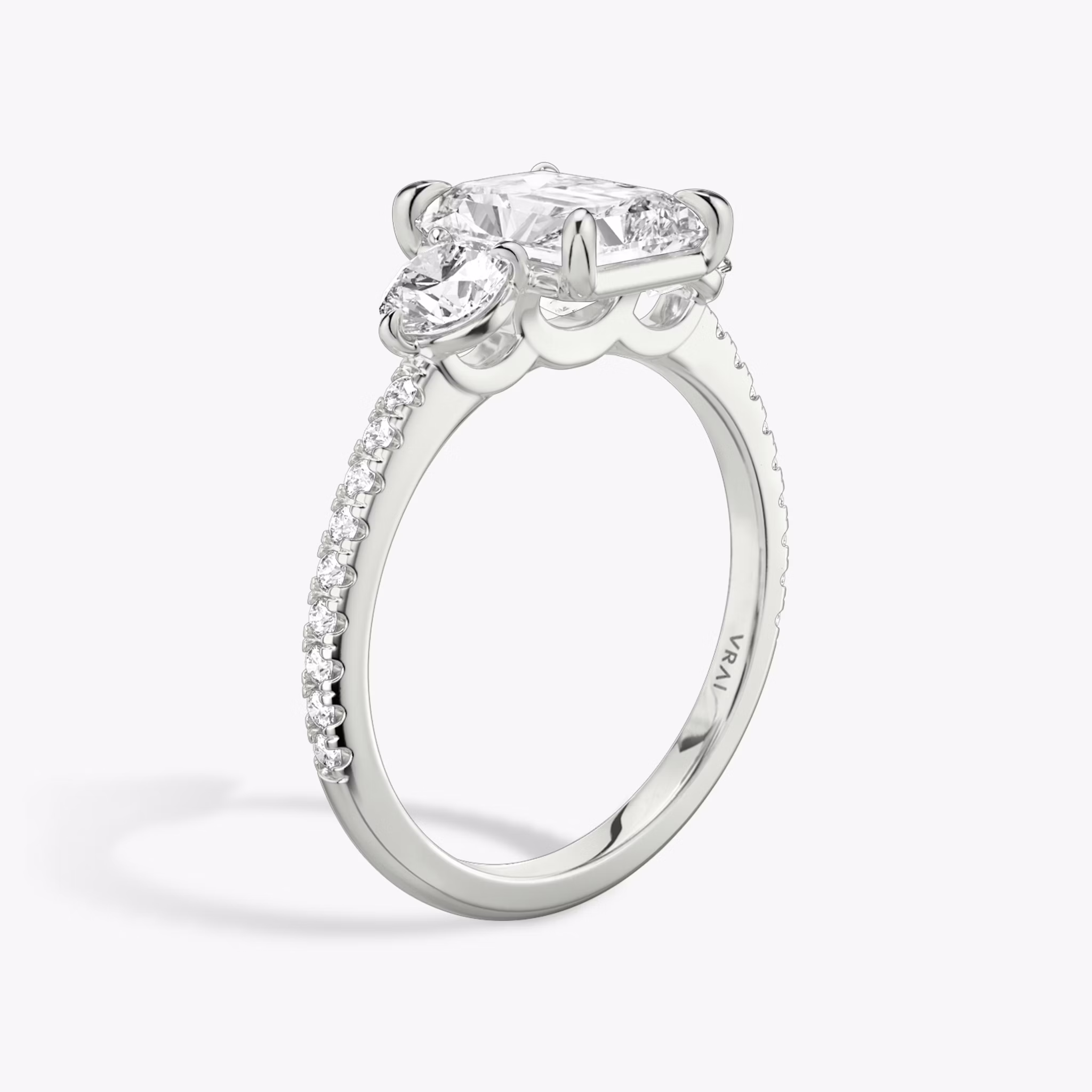 The Three Stone | Radiant | Platinum | bandAccent: Pavé | sideStoneCarat: 0.25ct | sideStoneShape: Round Brilliant | diamondOrientation: vertical | caratWeight: other