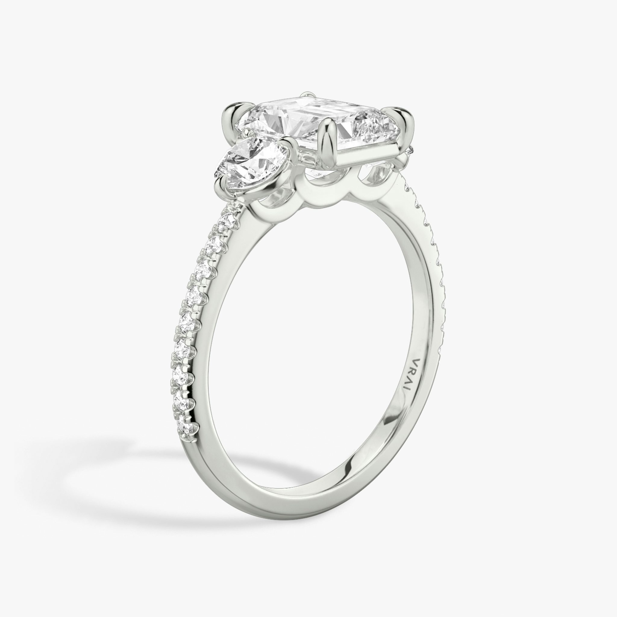 The Three Stone | Radiant | Platinum | bandAccent: Pavé | sideStoneCarat: 0.25ct | sideStoneShape: Round Brilliant | diamondOrientation: vertical | caratWeight: other