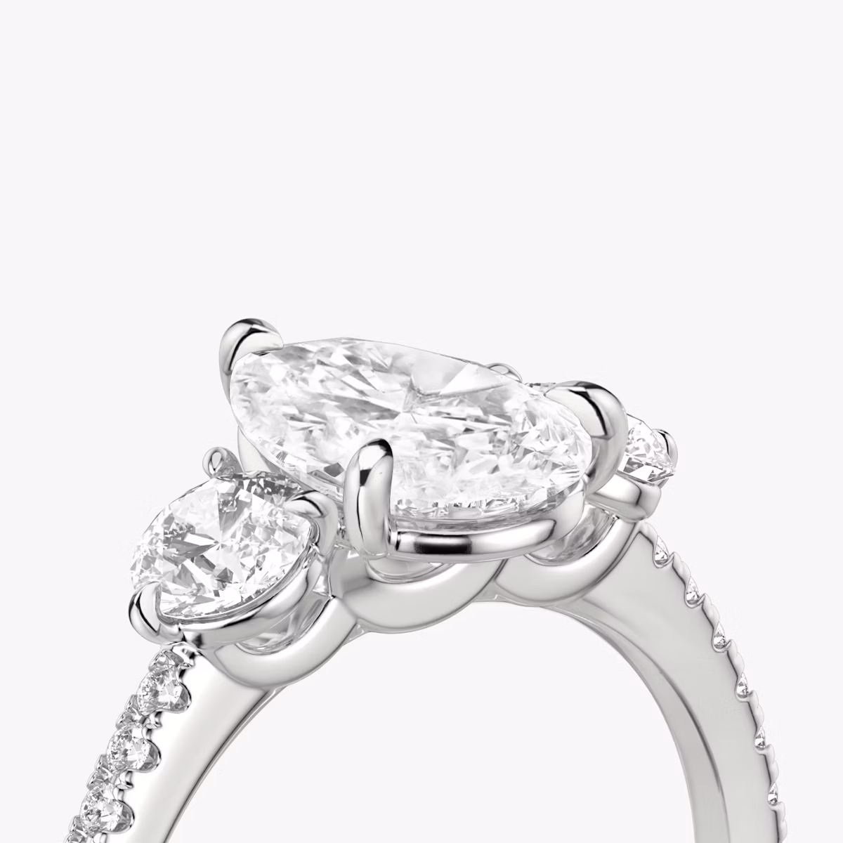 The Three Stone | Pear | Platinum | bandAccent: Pavé | sideStoneCarat: 0.25ct | sideStoneShape: Round Brilliant | diamondOrientation: vertical | caratWeight: other