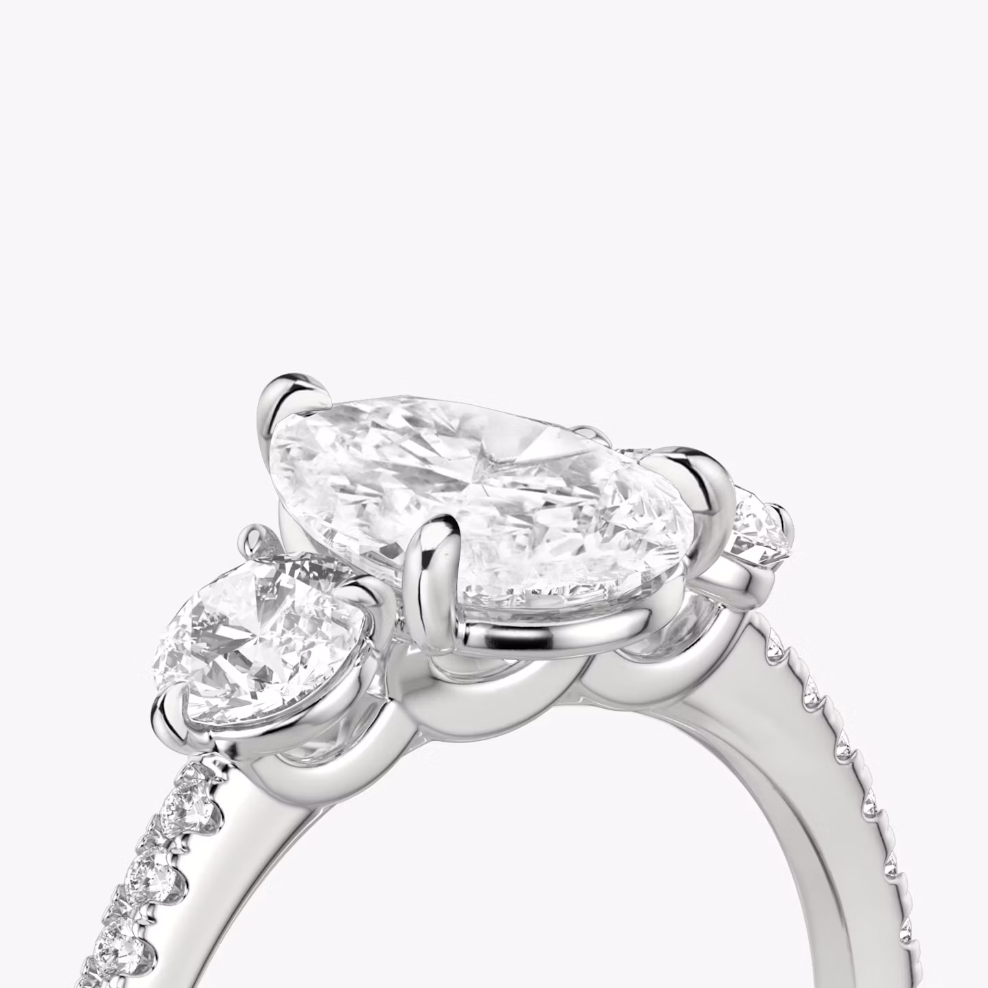The Three Stone | Pear | Platinum | bandAccent: Pavé | sideStoneCarat: 0.25ct | sideStoneShape: Round Brilliant | diamondOrientation: vertical | caratWeight: other