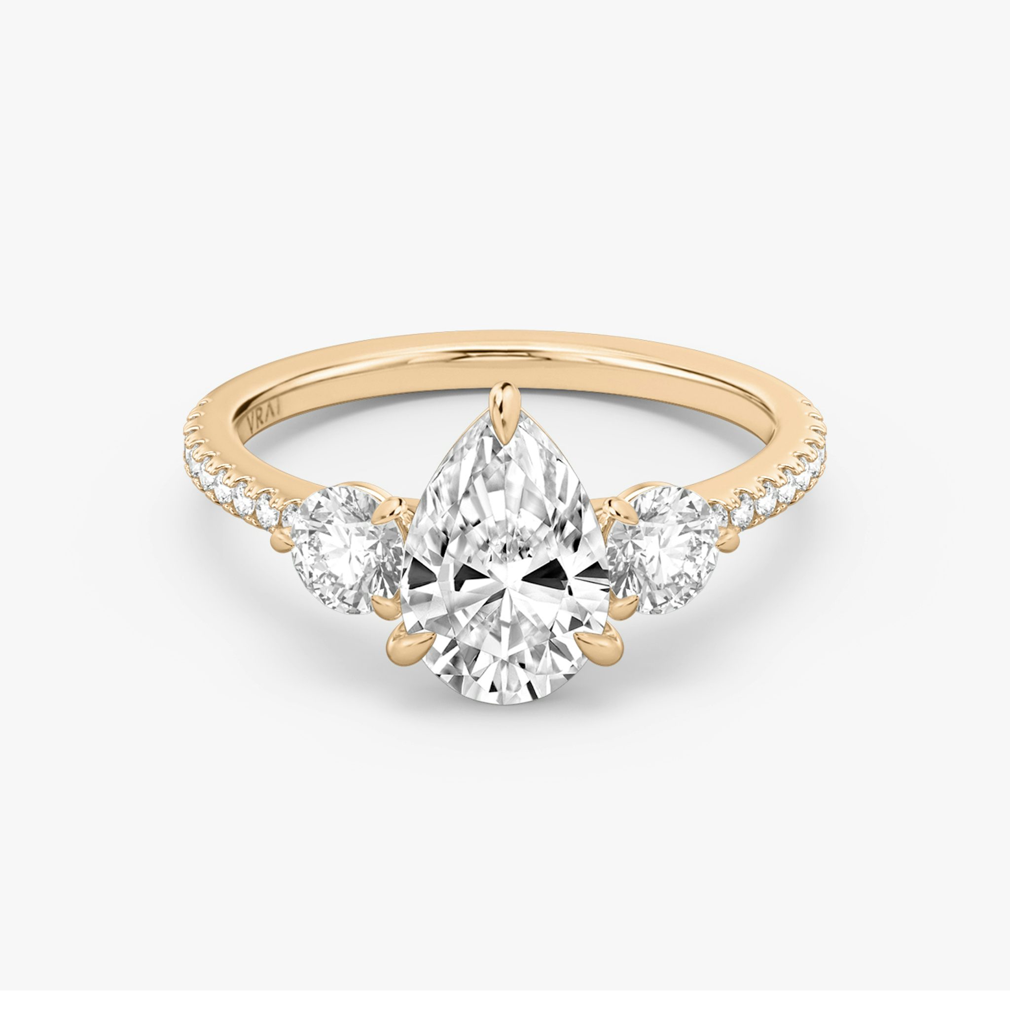 The Three Stone | Pear | 14k | Rose Gold | bandAccent: Pavé | sideStoneCarat: 0.25ct | sideStoneShape: Round Brilliant | diamondOrientation: vertical | caratWeight: other
