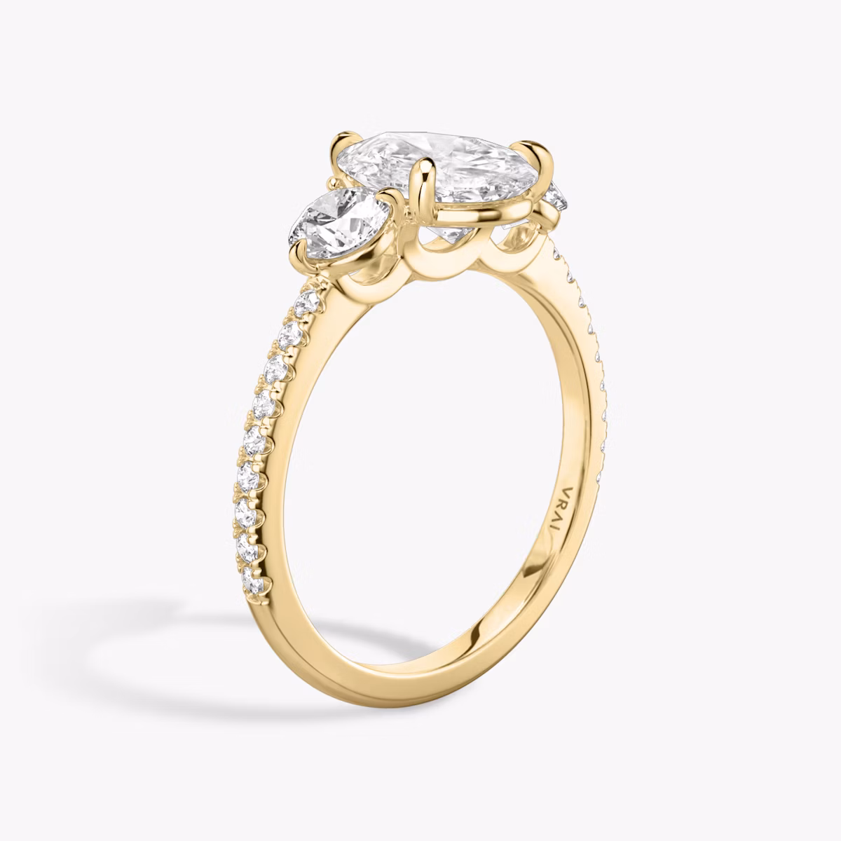 The Three Stone | Pear | 18k | Yellow Gold | bandAccent: Pavé | sideStoneCarat: 0.25ct | sideStoneShape: Round Brilliant | diamondOrientation: vertical | caratWeight: other