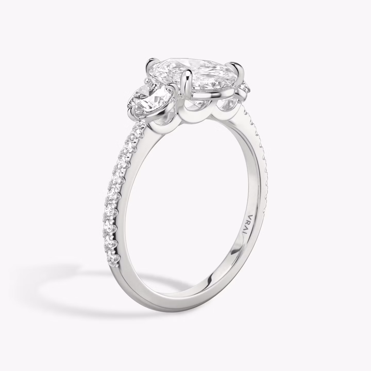 The Three Stone | Pear | Platinum | bandAccent: Pavé | sideStoneCarat: 0.25ct | sideStoneShape: Round Brilliant | diamondOrientation: vertical | caratWeight: other