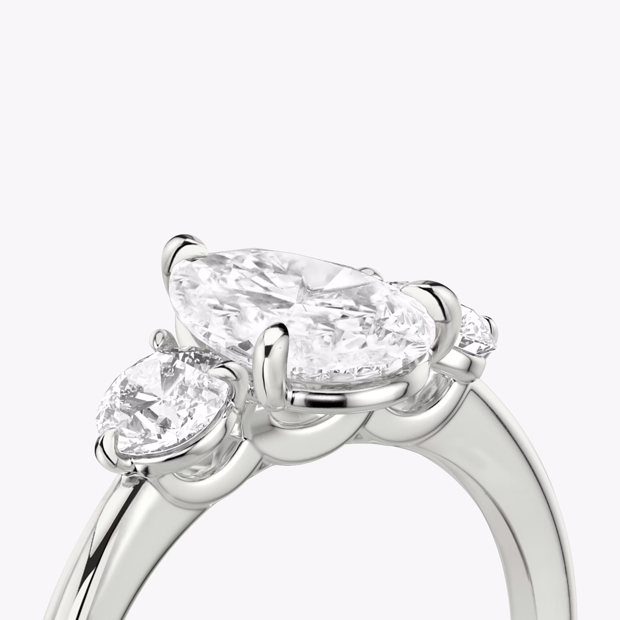The Three Stone | Pear | Platinum | bandAccent: Plain | sideStoneCarat: 0.25ct | sideStoneShape: Round Brilliant | diamondOrientation: vertical | caratWeight: other