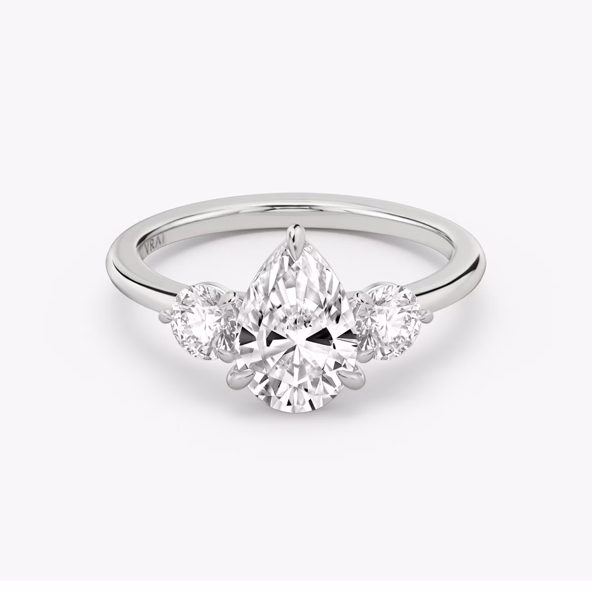 The Three Stone | Pear | Platinum | bandAccent: Plain | sideStoneCarat: 0.25ct | sideStoneShape: Round Brilliant | diamondOrientation: vertical | caratWeight: other