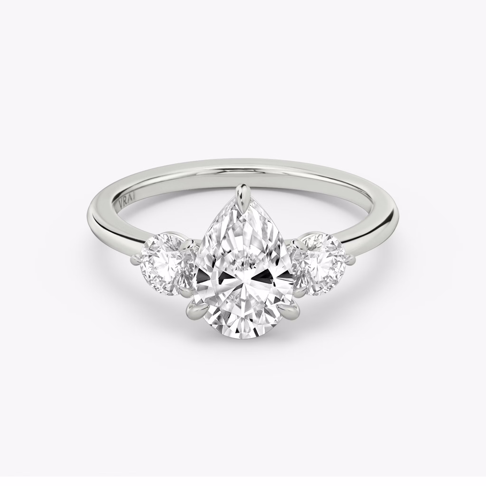 The Three Stone | Pear | Platinum | bandAccent: Plain | sideStoneCarat: 0.25ct | sideStoneShape: Round Brilliant | diamondOrientation: vertical | caratWeight: other