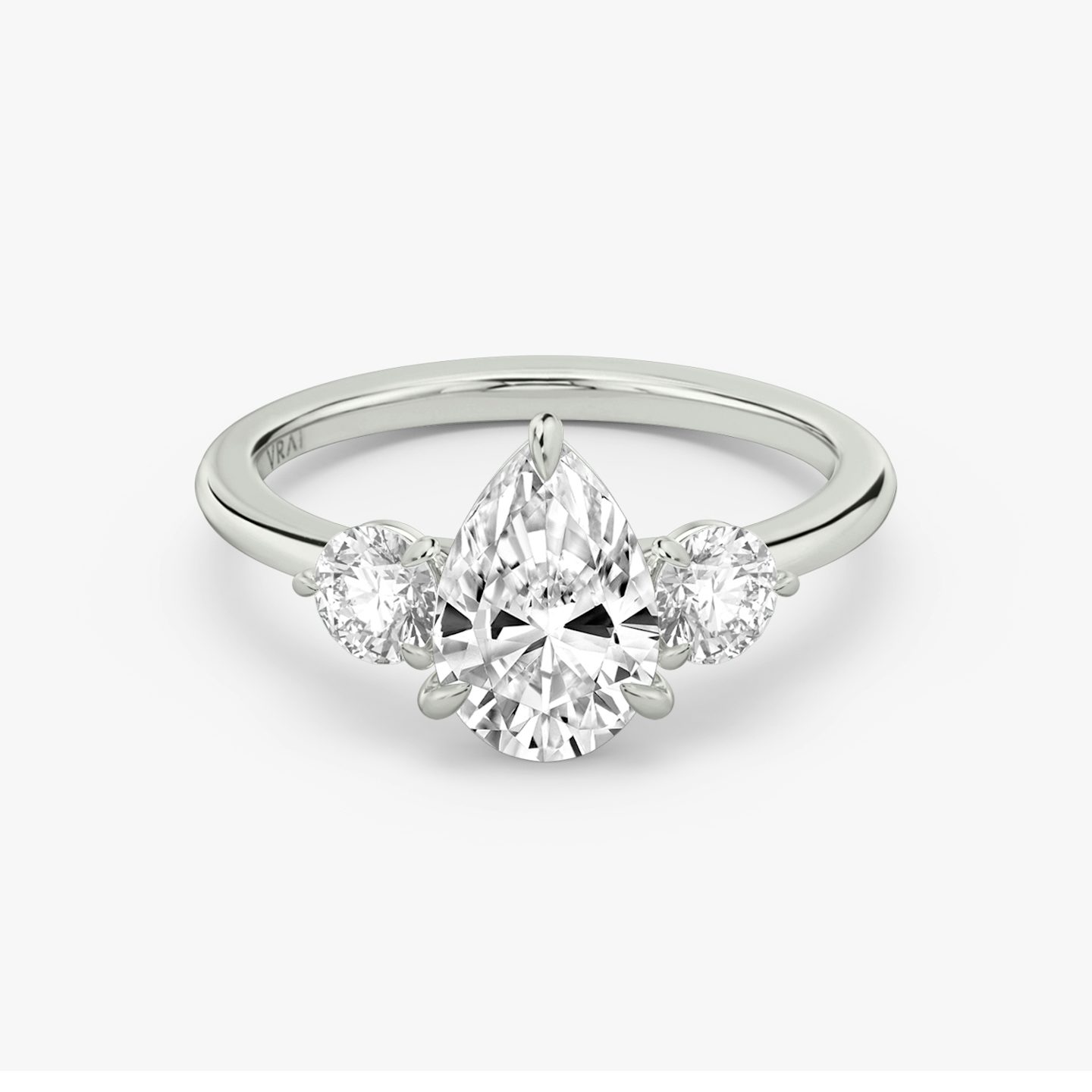 The Three Stone | Pear | 18k | White Gold | bandAccent: Plain | sideStoneCarat: 0.25ct | sideStoneShape: Round Brilliant | diamondOrientation: vertical | caratWeight: other