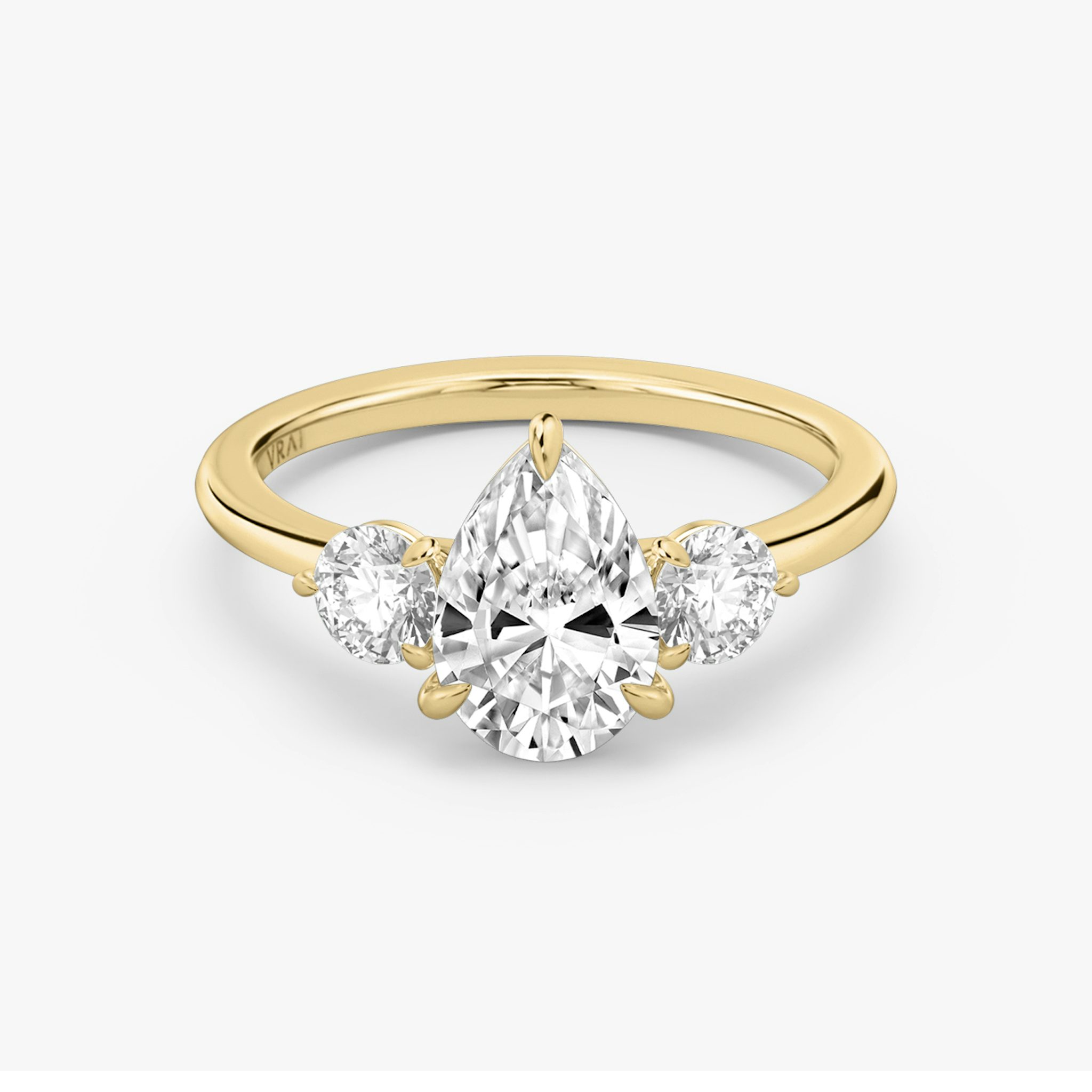 The Three Stone | Pear | 18k | Yellow Gold | bandAccent: Plain | sideStoneCarat: 0.25ct | sideStoneShape: Round Brilliant | diamondOrientation: vertical | caratWeight: other