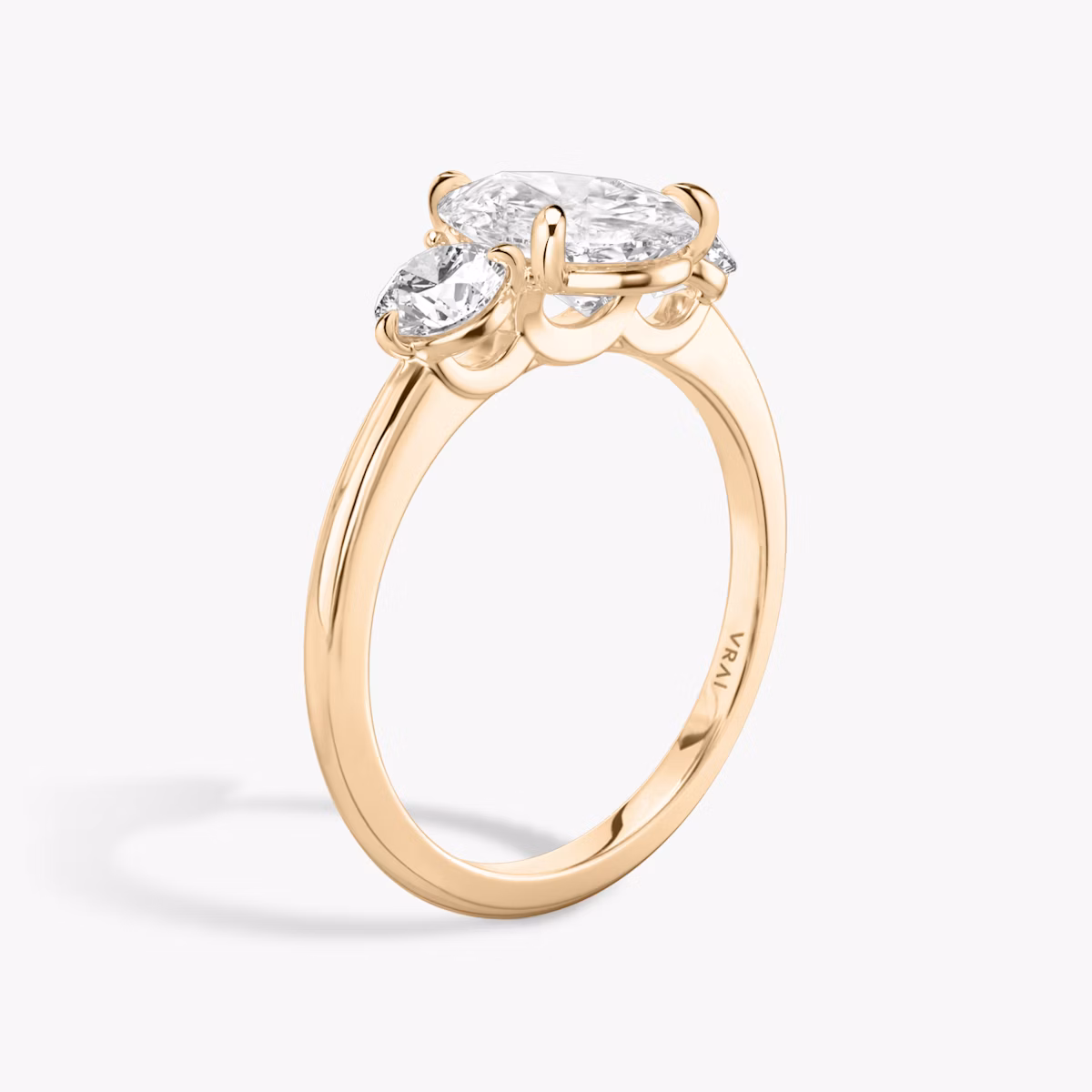 The Three Stone | Pear | 14k | Rose Gold | bandAccent: Plain | sideStoneCarat: 0.25ct | sideStoneShape: Round Brilliant | diamondOrientation: vertical | caratWeight: other
