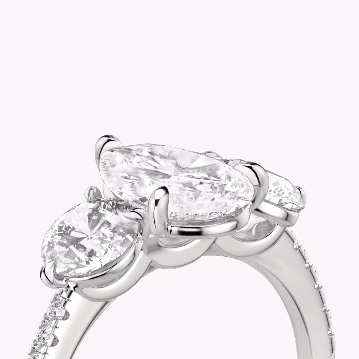 The Three Stone | Pear | Platinum | bandAccent: Pavé | sideStoneCarat: 0.50ct | sideStoneShape: Round Brilliant | diamondOrientation: vertical | caratWeight: other