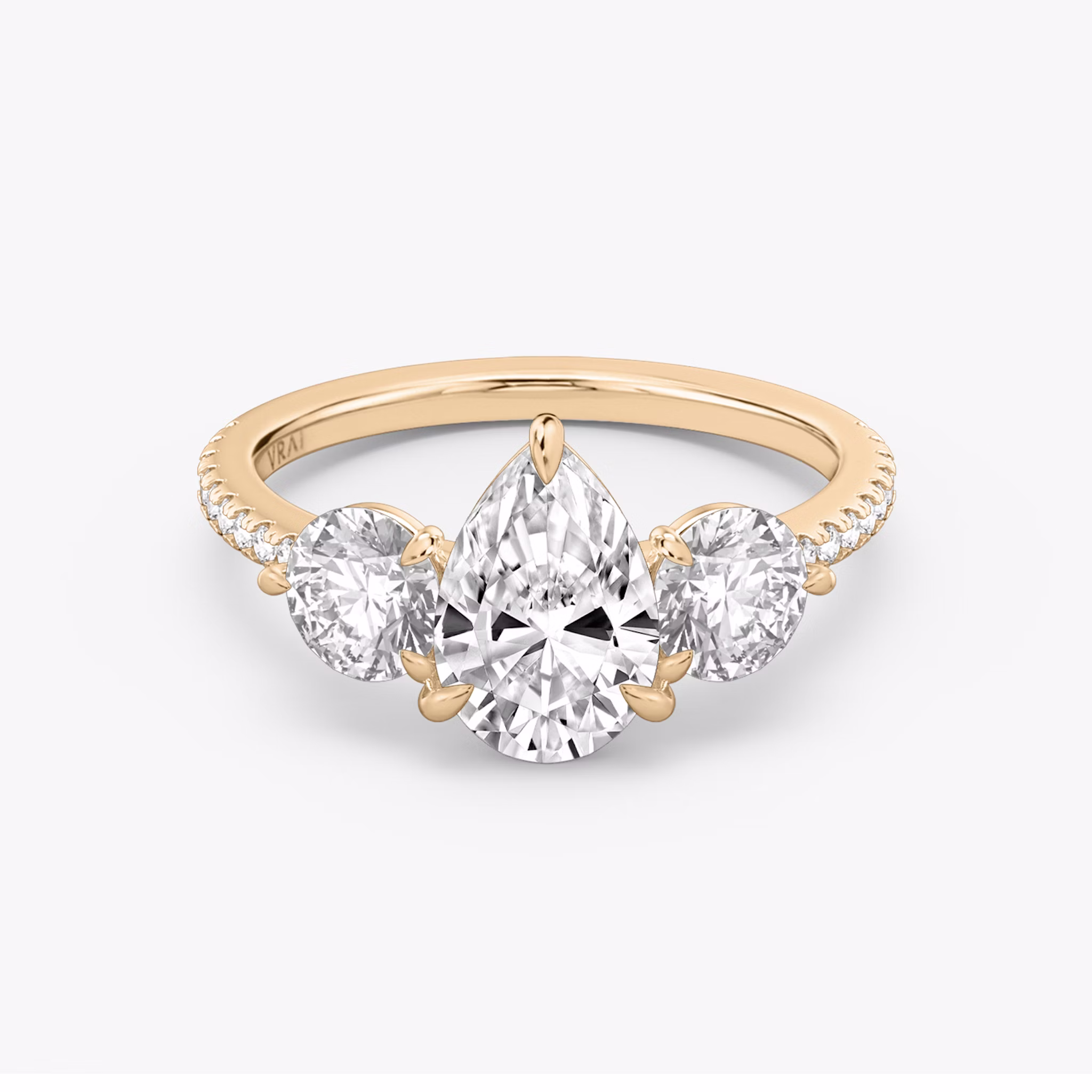 The Three Stone | Pear | 14k | Rose Gold | bandAccent: Pavé | sideStoneCarat: 0.50ct | sideStoneShape: Round Brilliant | diamondOrientation: vertical | caratWeight: other