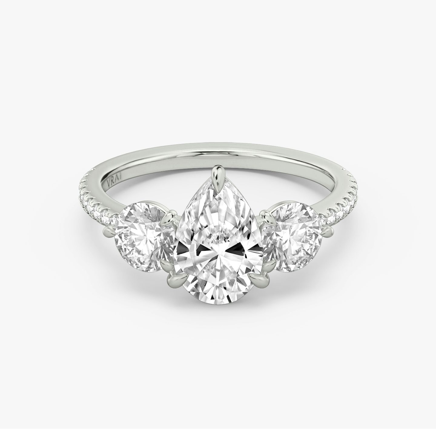 The Three Stone | Pear | Platinum | bandAccent: Pavé | sideStoneCarat: 0.50ct | sideStoneShape: Round Brilliant | diamondOrientation: vertical | caratWeight: other