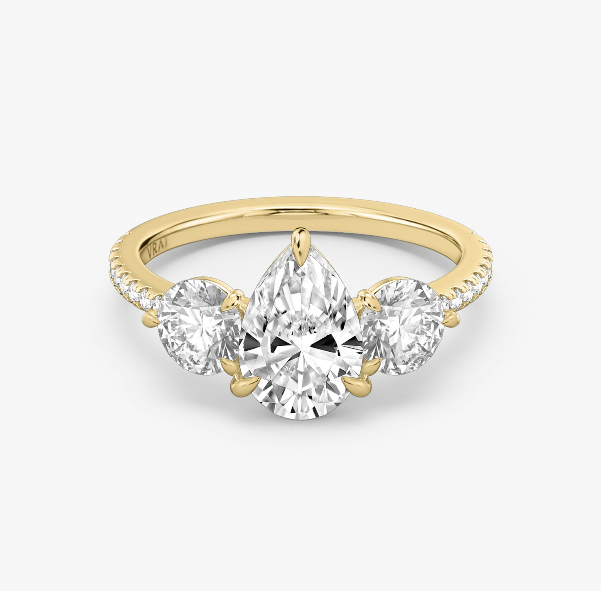The Three Stone | Pear | 18k | Yellow Gold | bandAccent: Pavé | sideStoneCarat: 0.50ct | sideStoneShape: Round Brilliant | diamondOrientation: vertical | caratWeight: other
