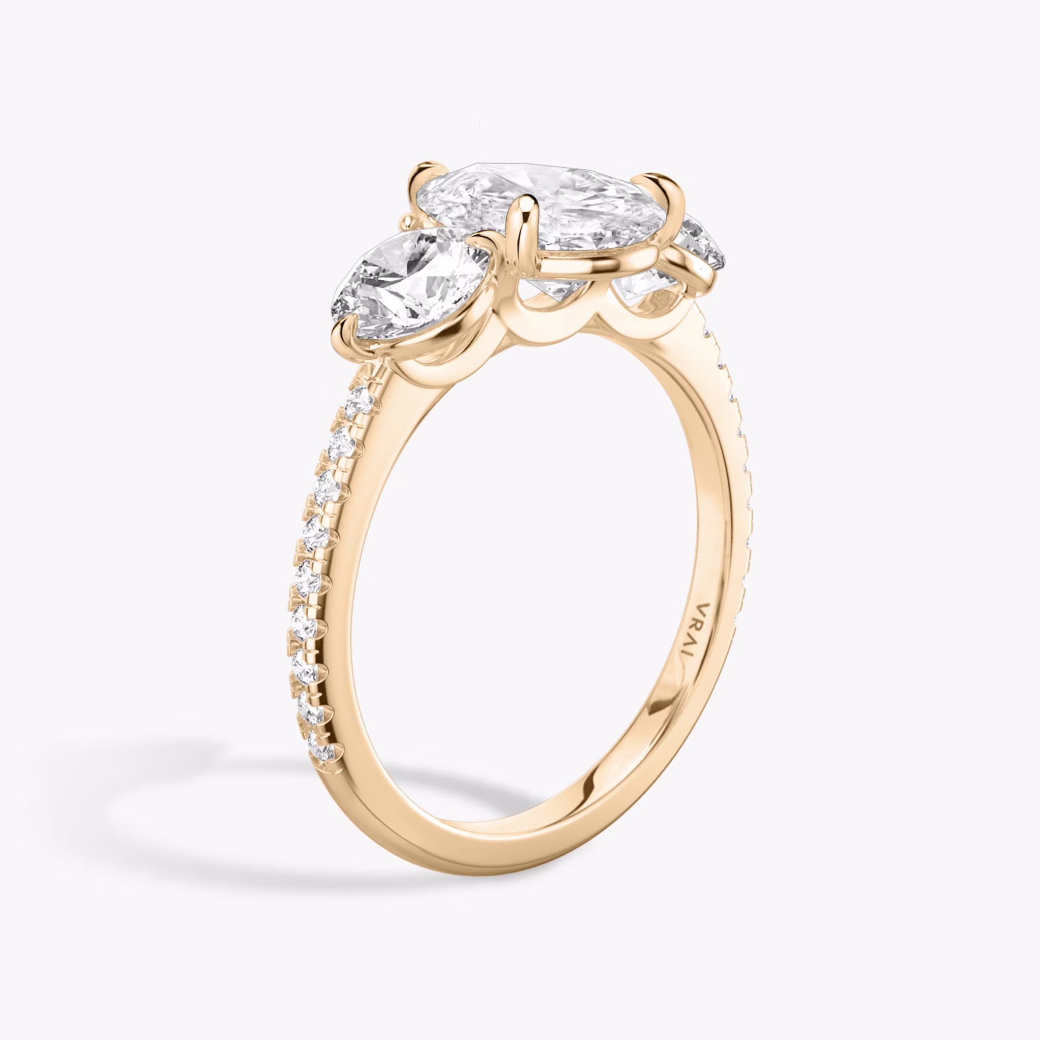 The Three Stone | Pear | 14k | Rose Gold | bandAccent: Pavé | sideStoneCarat: 0.50ct | sideStoneShape: Round Brilliant | diamondOrientation: vertical | caratWeight: other