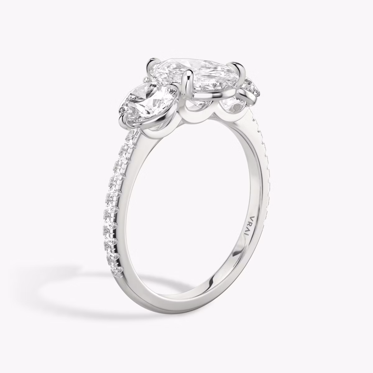 The Three Stone | Pear | Platinum | bandAccent: Pavé | sideStoneCarat: 0.50ct | sideStoneShape: Round Brilliant | diamondOrientation: vertical | caratWeight: other