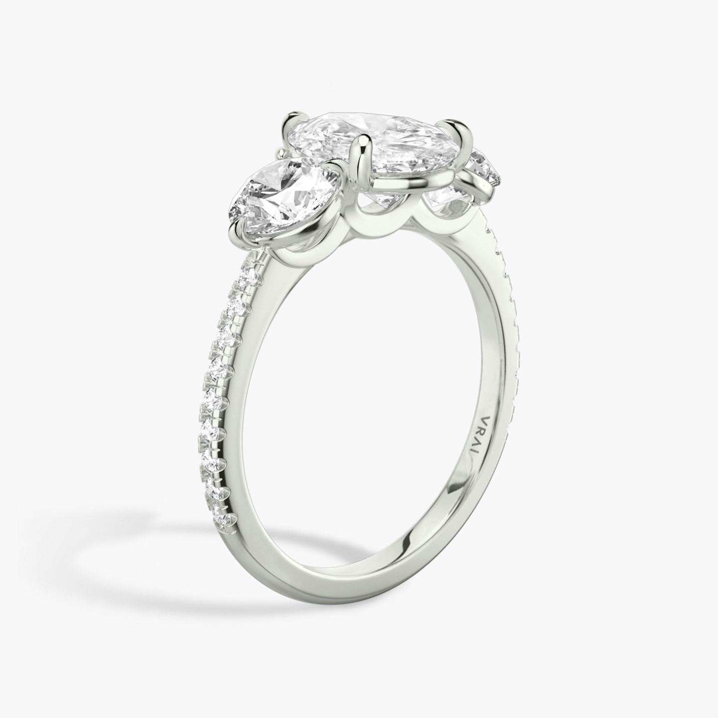 The Three Stone | Pear | Platinum | bandAccent: Pavé | sideStoneCarat: 0.50ct | sideStoneShape: Round Brilliant | diamondOrientation: vertical | caratWeight: other