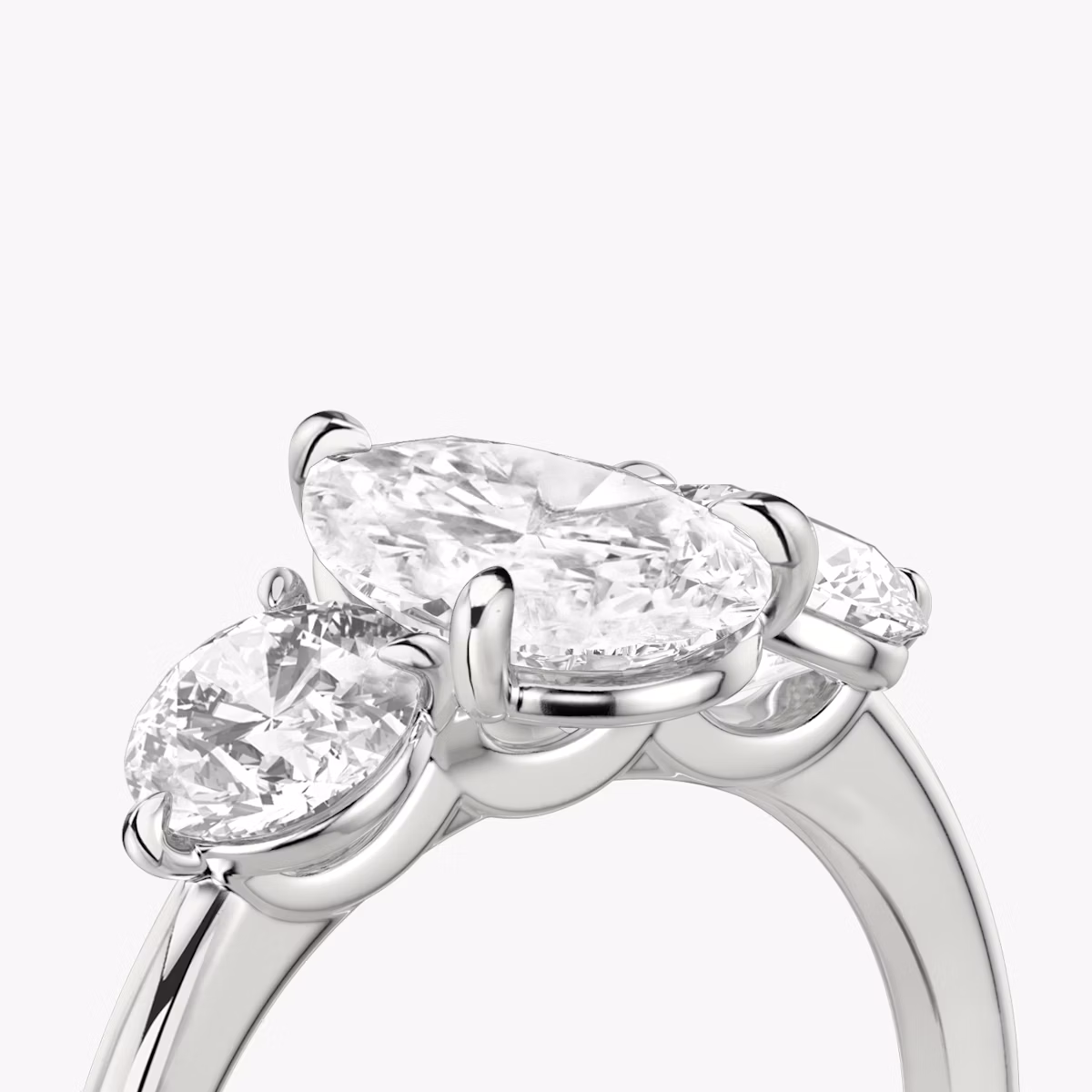 The Three Stone | Pear | Platinum | bandAccent: Plain | sideStoneCarat: 0.50ct | sideStoneShape: Round Brilliant | diamondOrientation: vertical | caratWeight: other