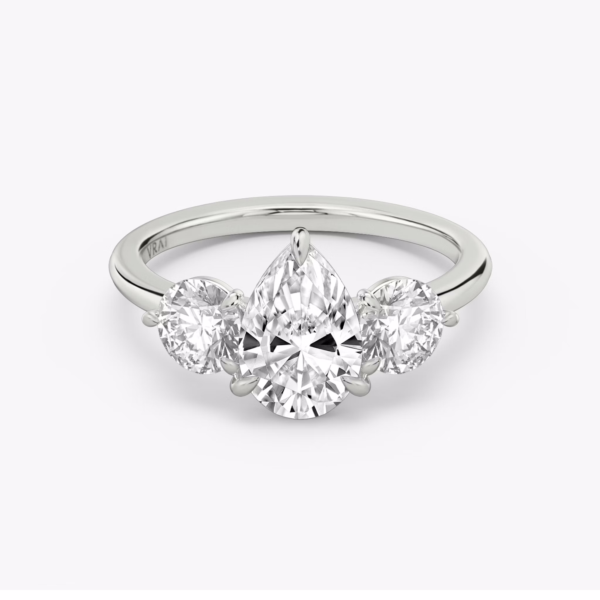 The Three Stone | Pear | 18k | White Gold | bandAccent: Plain | sideStoneCarat: 0.50ct | sideStoneShape: Round Brilliant | diamondOrientation: vertical | caratWeight: other
