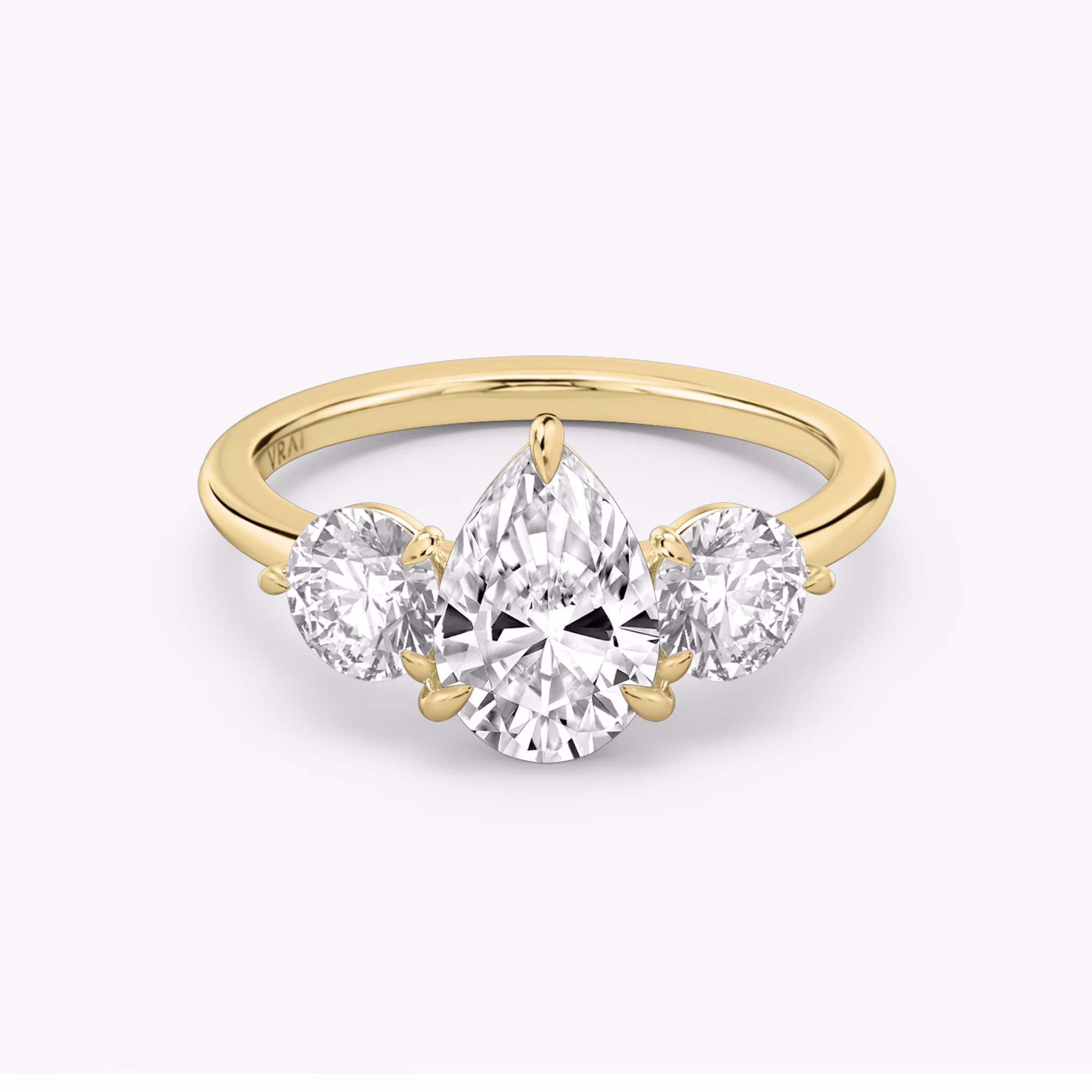 The Three Stone | Pear | 18k | Yellow Gold | bandAccent: Plain | sideStoneCarat: 0.50ct | sideStoneShape: Round Brilliant | diamondOrientation: vertical | caratWeight: other