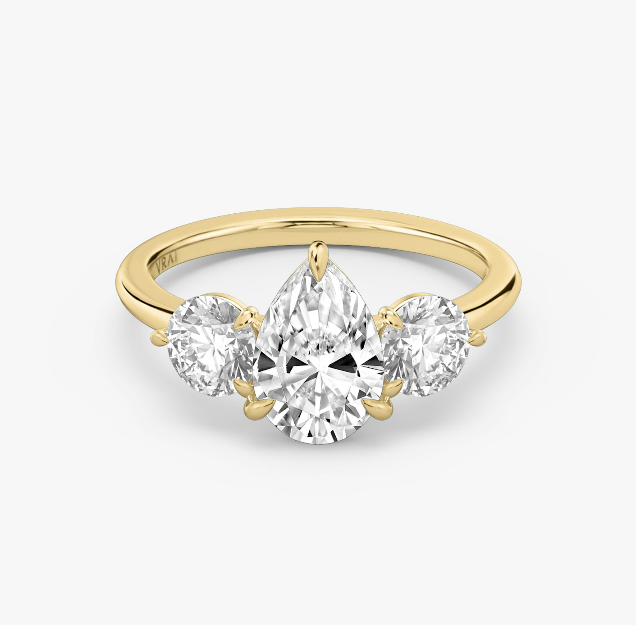 The Three Stone | Pear | 18k | Yellow Gold | bandAccent: Plain | sideStoneCarat: 0.50ct | sideStoneShape: Round Brilliant | diamondOrientation: vertical | caratWeight: other