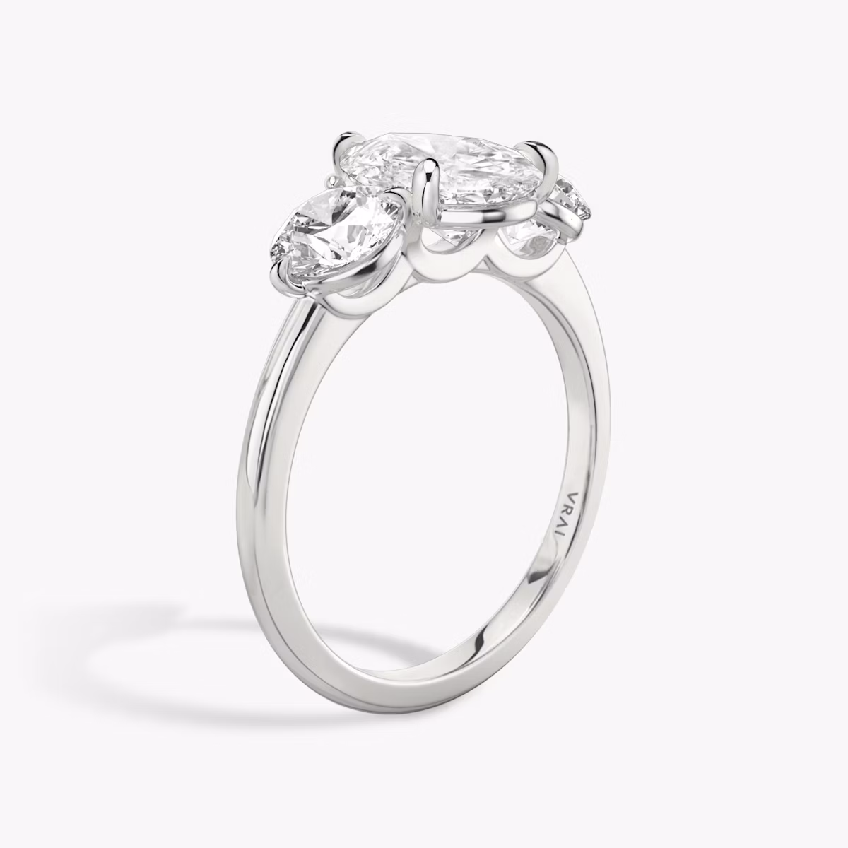 The Three Stone | Pear | Platinum | bandAccent: Plain | sideStoneCarat: 0.50ct | sideStoneShape: Round Brilliant | diamondOrientation: vertical | caratWeight: other