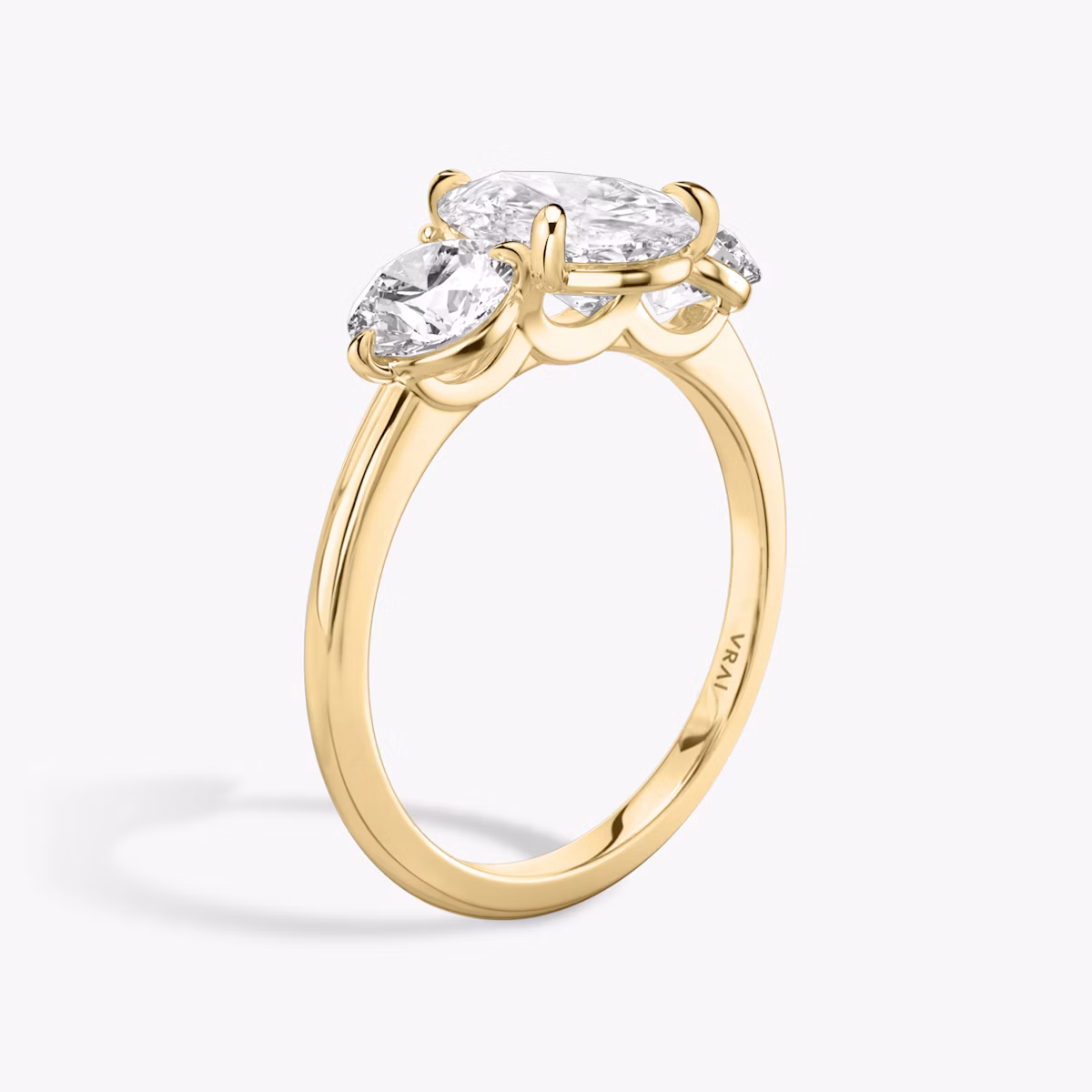 The Three Stone | Pear | 18k | Yellow Gold | bandAccent: Plain | sideStoneCarat: 0.50ct | sideStoneShape: Round Brilliant | diamondOrientation: vertical | caratWeight: other