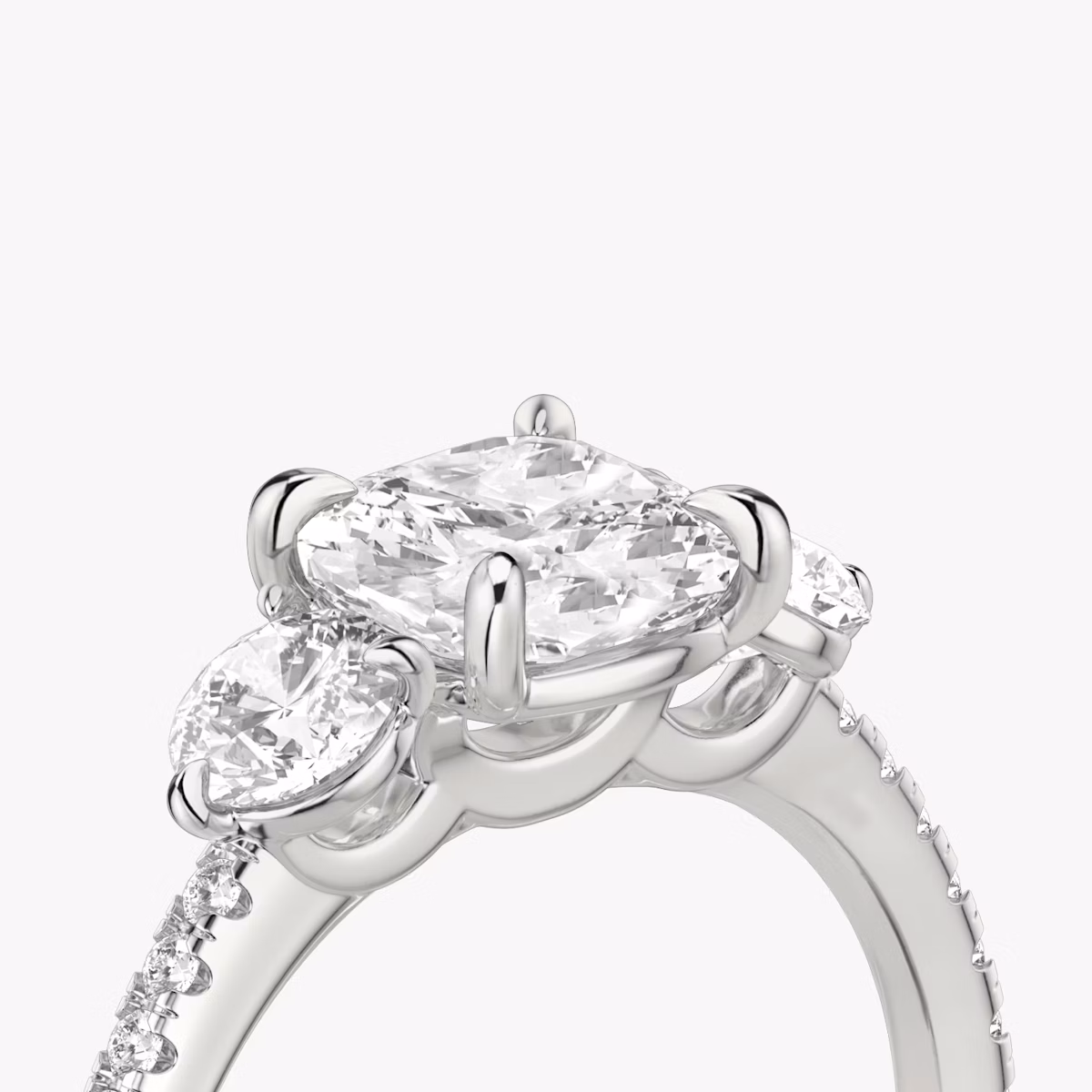 The Three Stone | Cushion | Platinum | bandAccent: Pavé | sideStoneCarat: 0.25ct | sideStoneShape: Round Brilliant | diamondOrientation: vertical | caratWeight: other