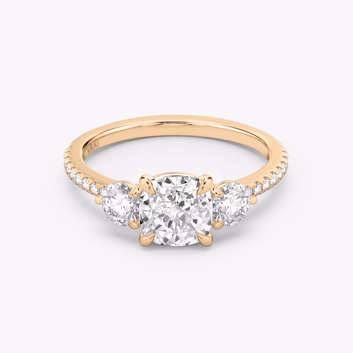 The Three Stone | Cushion | 14k | Rose Gold | bandAccent: Pavé | sideStoneCarat: 0.25ct | sideStoneShape: Round Brilliant | diamondOrientation: vertical | caratWeight: other