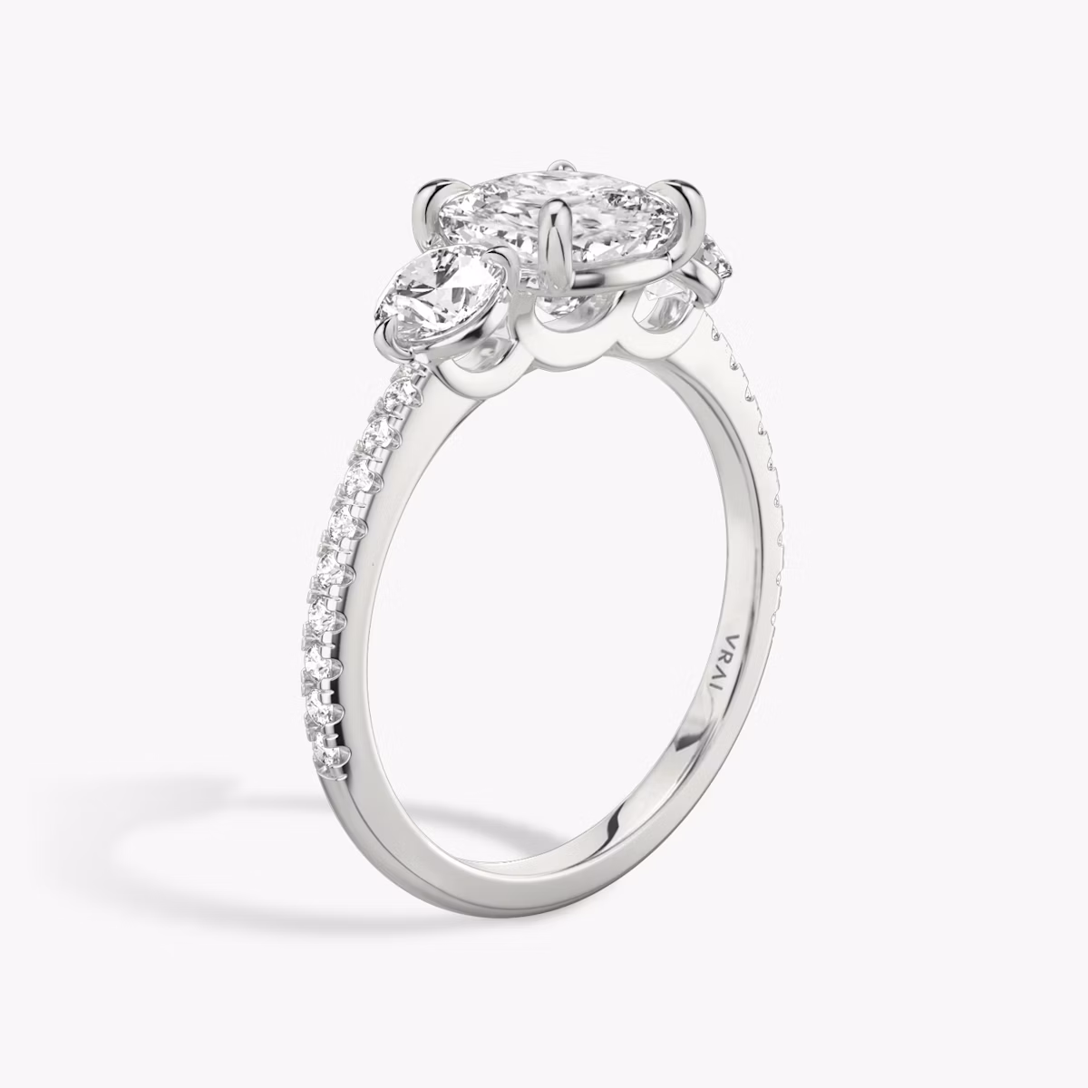 The Three Stone | Cushion | Platinum | bandAccent: Pavé | sideStoneCarat: 0.25ct | sideStoneShape: Round Brilliant | diamondOrientation: vertical | caratWeight: other