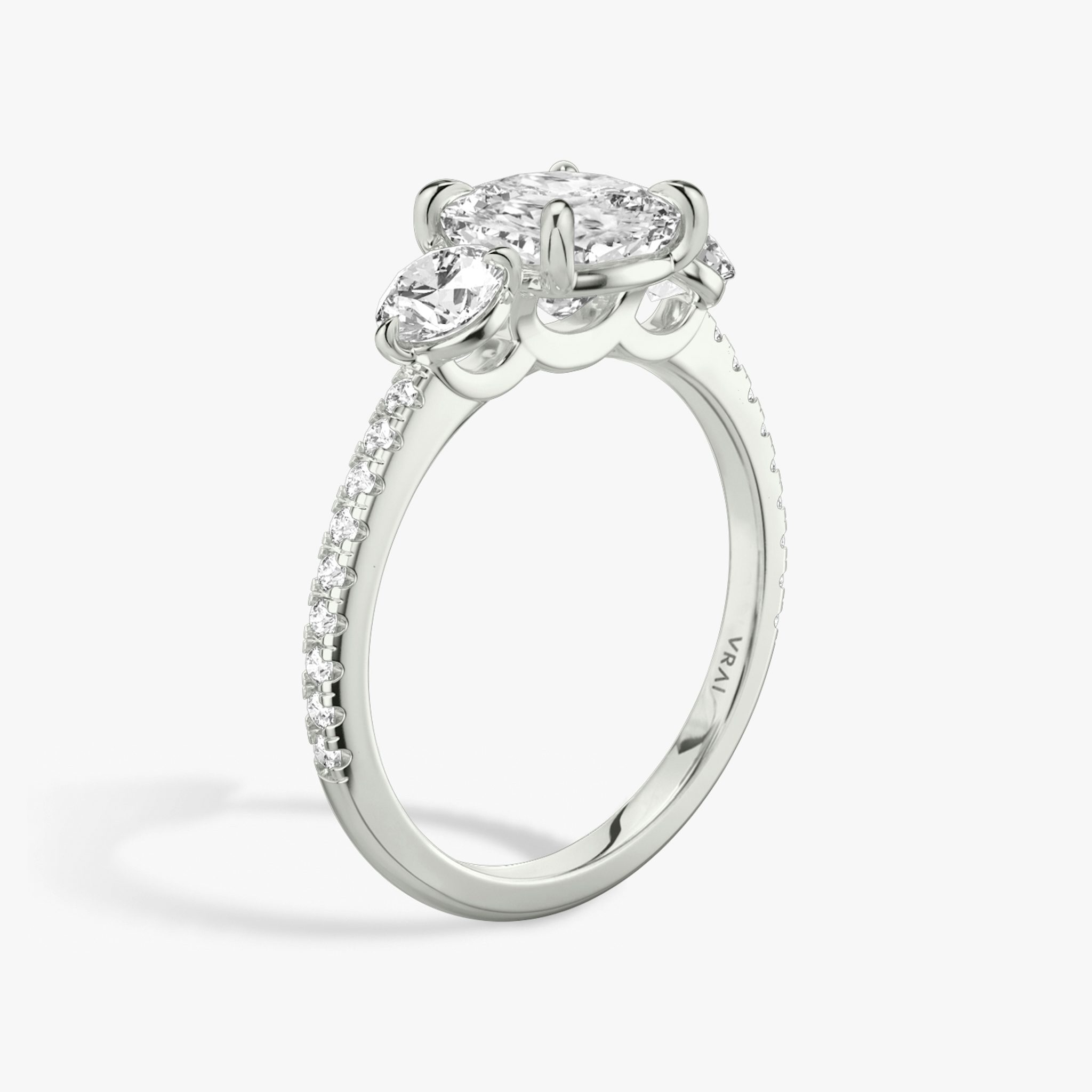 The Three Stone | Cushion | 18k | White Gold | bandAccent: Pavé | sideStoneCarat: 0.25ct | sideStoneShape: Round Brilliant | diamondOrientation: vertical | caratWeight: other