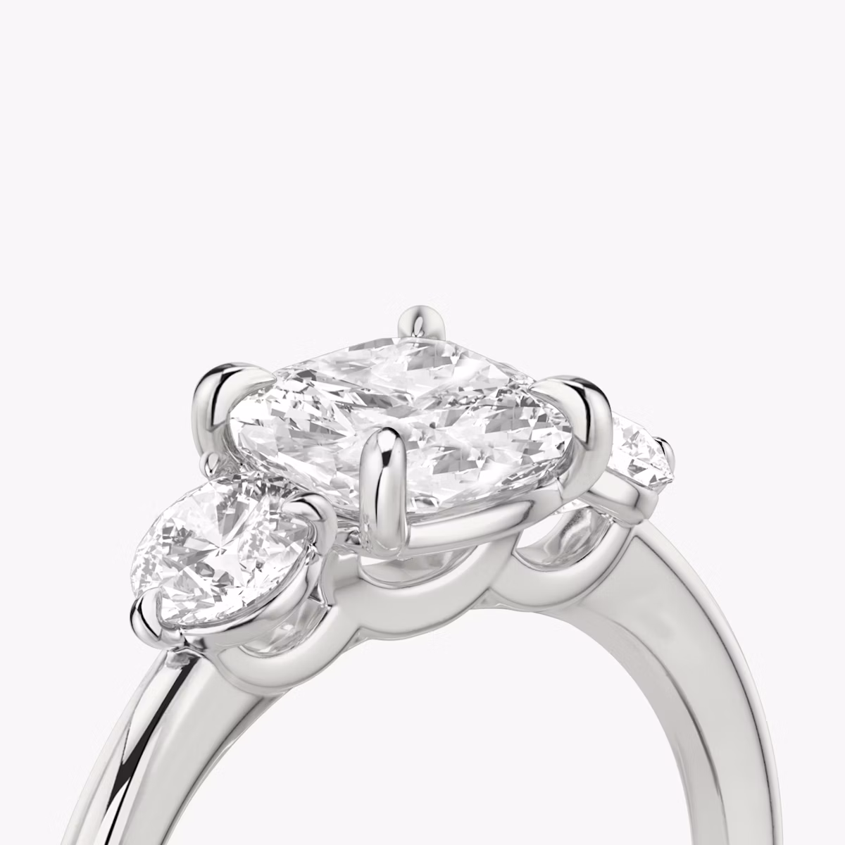 The Three Stone | Cushion | 18k | White Gold | bandAccent: Plain | sideStoneCarat: 0.25ct | sideStoneShape: Round Brilliant | diamondOrientation: vertical | caratWeight: other