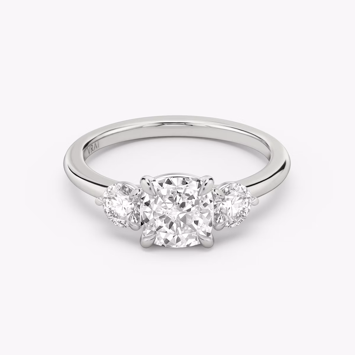 The Three Stone | Cushion | 18k | White Gold | bandAccent: Plain | sideStoneCarat: 0.25ct | sideStoneShape: Round Brilliant | diamondOrientation: vertical | caratWeight: other