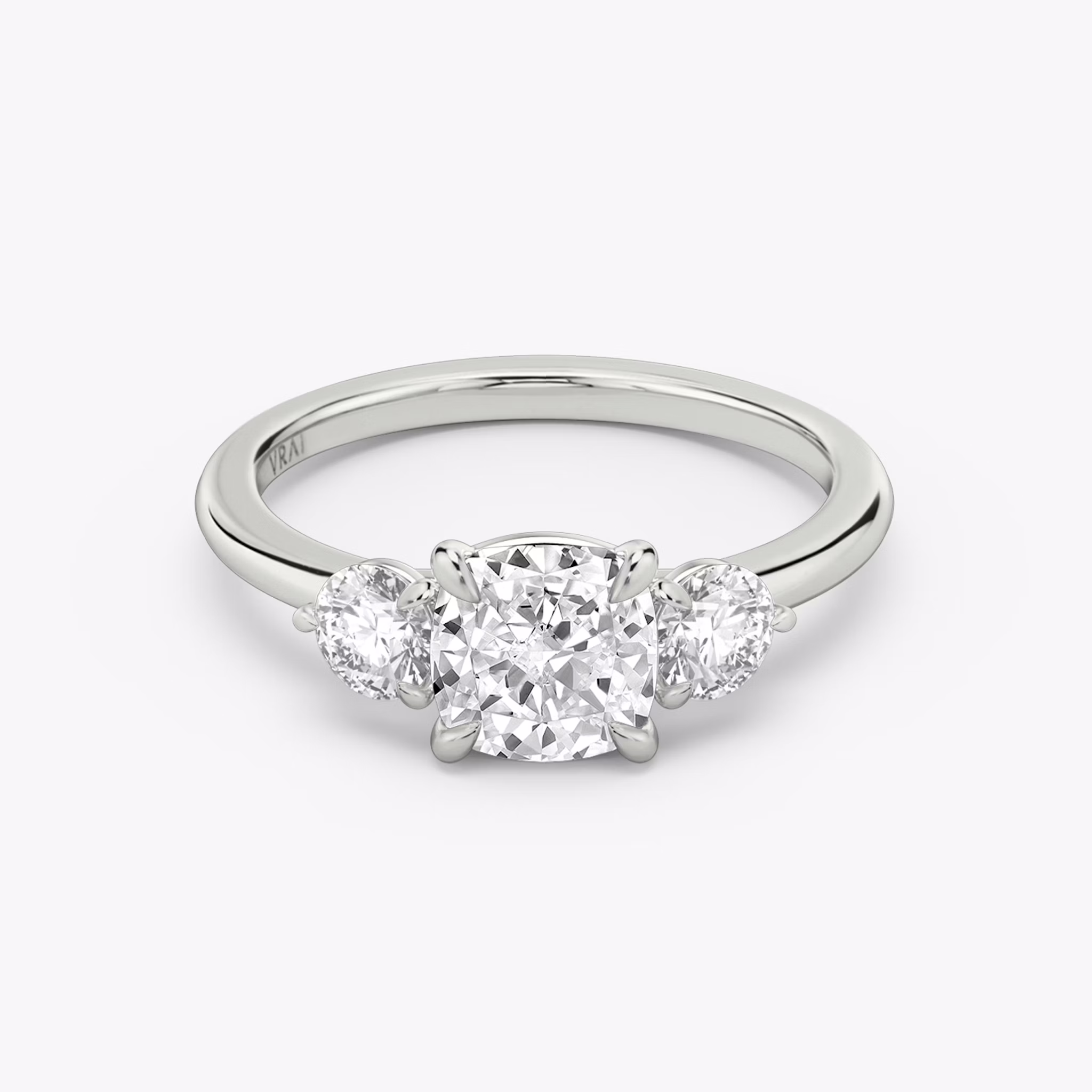 The Three Stone | Cushion | Platinum | bandAccent: Plain | sideStoneCarat: 0.25ct | sideStoneShape: Round Brilliant | diamondOrientation: vertical | caratWeight: other