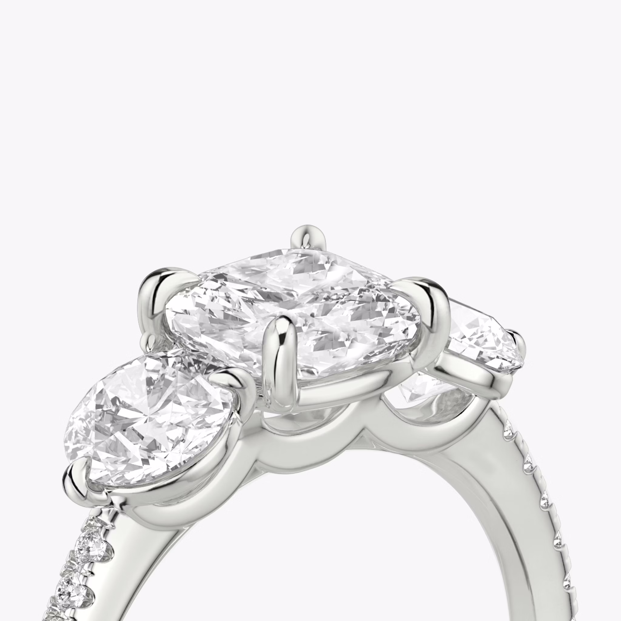 The Three Stone | Cushion | 18k | White Gold | bandAccent: Pavé | sideStoneCarat: 0.50ct | sideStoneShape: Round Brilliant | diamondOrientation: vertical | caratWeight: other