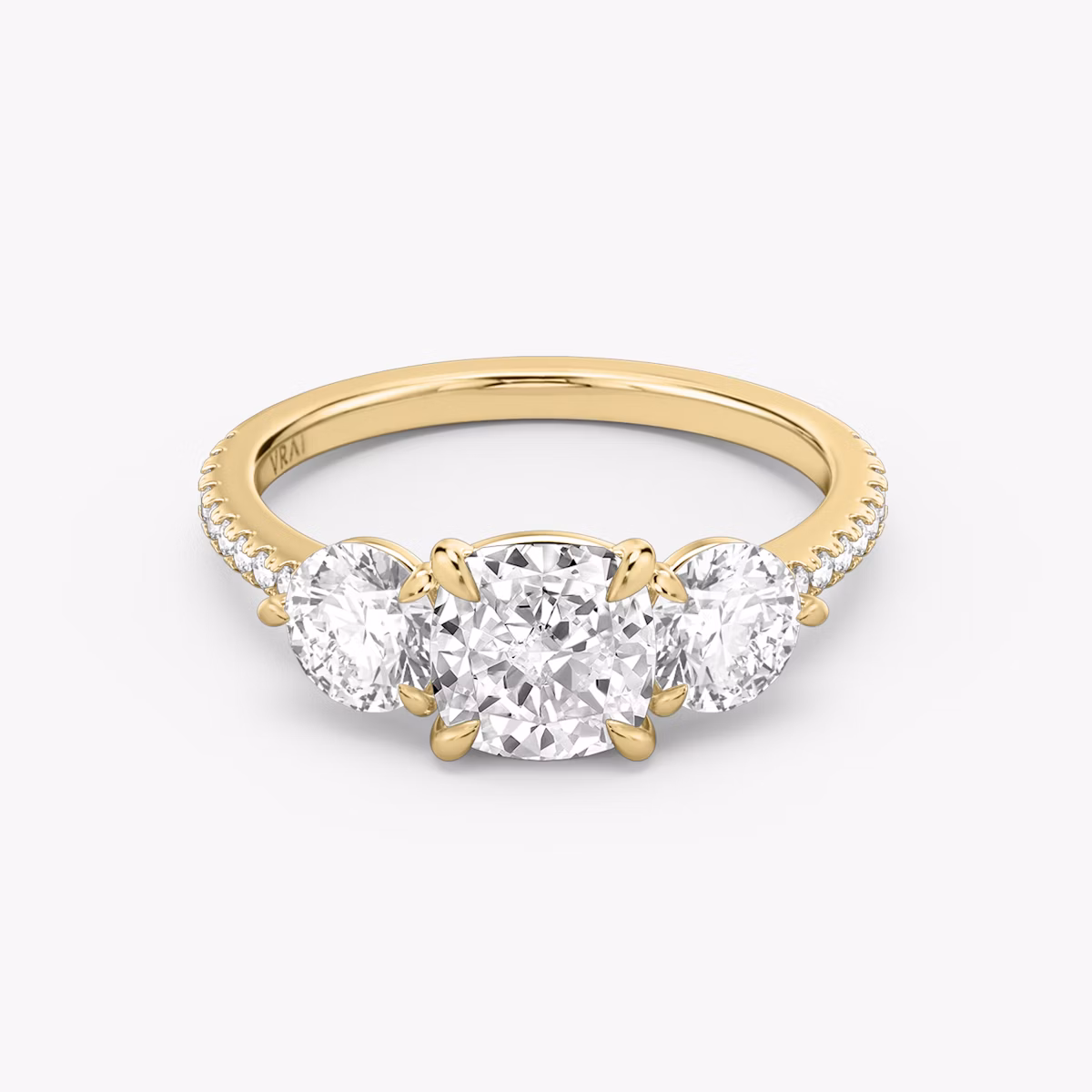 The Three Stone | Cushion | 18k | Yellow Gold | bandAccent: Pavé | sideStoneCarat: 0.50ct | sideStoneShape: Round Brilliant | diamondOrientation: vertical | caratWeight: other