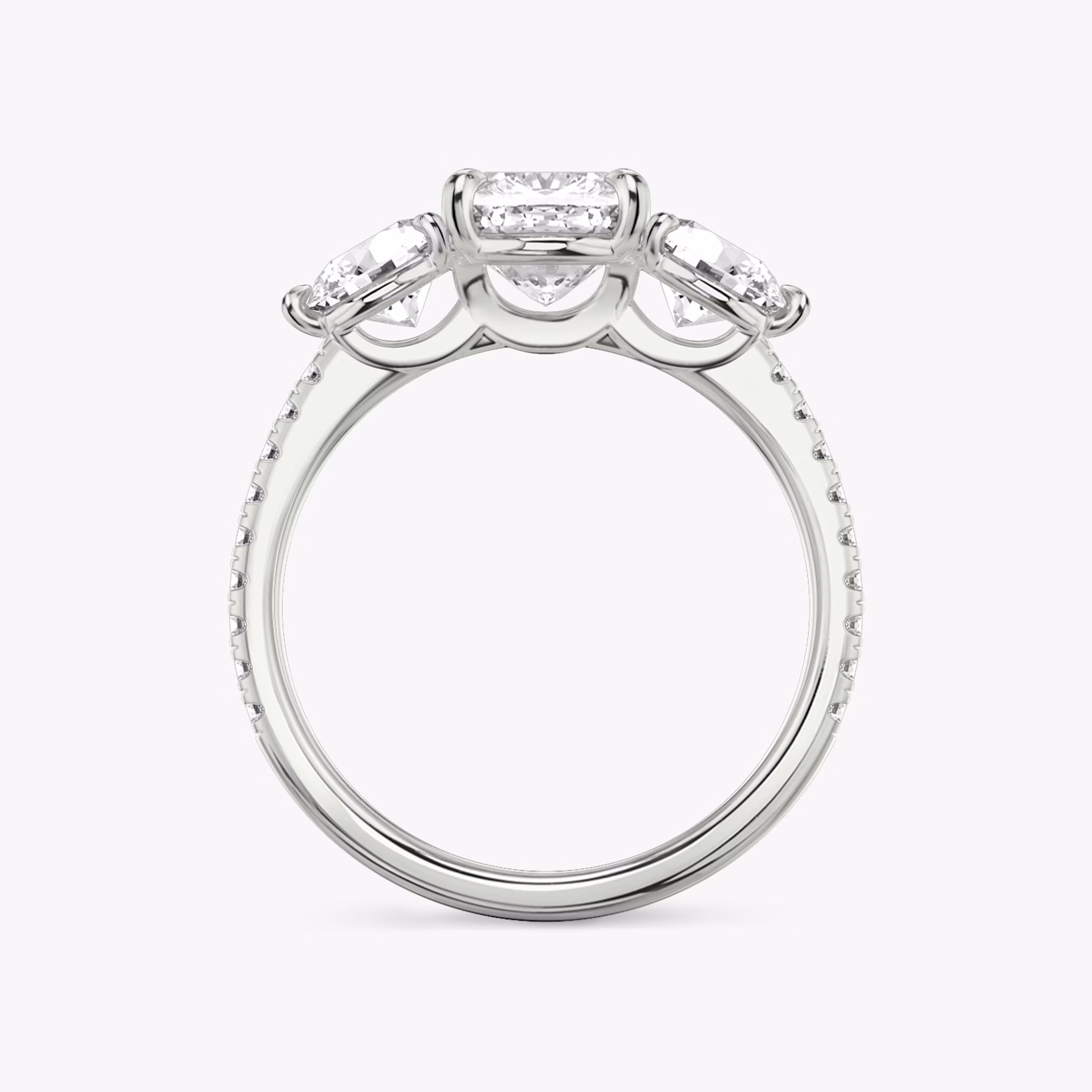 The Three Stone | Cushion | 18k | White Gold | bandAccent: Pavé | sideStoneCarat: 0.50ct | sideStoneShape: Round Brilliant | diamondOrientation: vertical | caratWeight: other