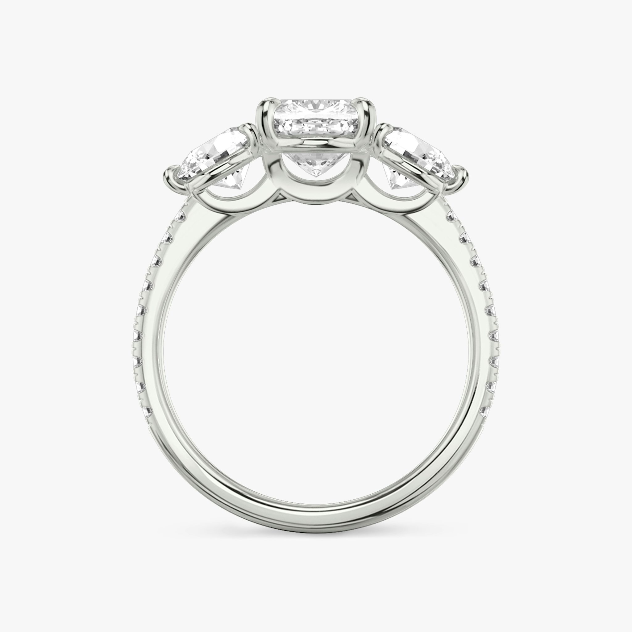 The Three Stone | Cushion | 18k | White Gold | bandAccent: Pavé | sideStoneCarat: 0.50ct | sideStoneShape: Round Brilliant | diamondOrientation: vertical | caratWeight: other