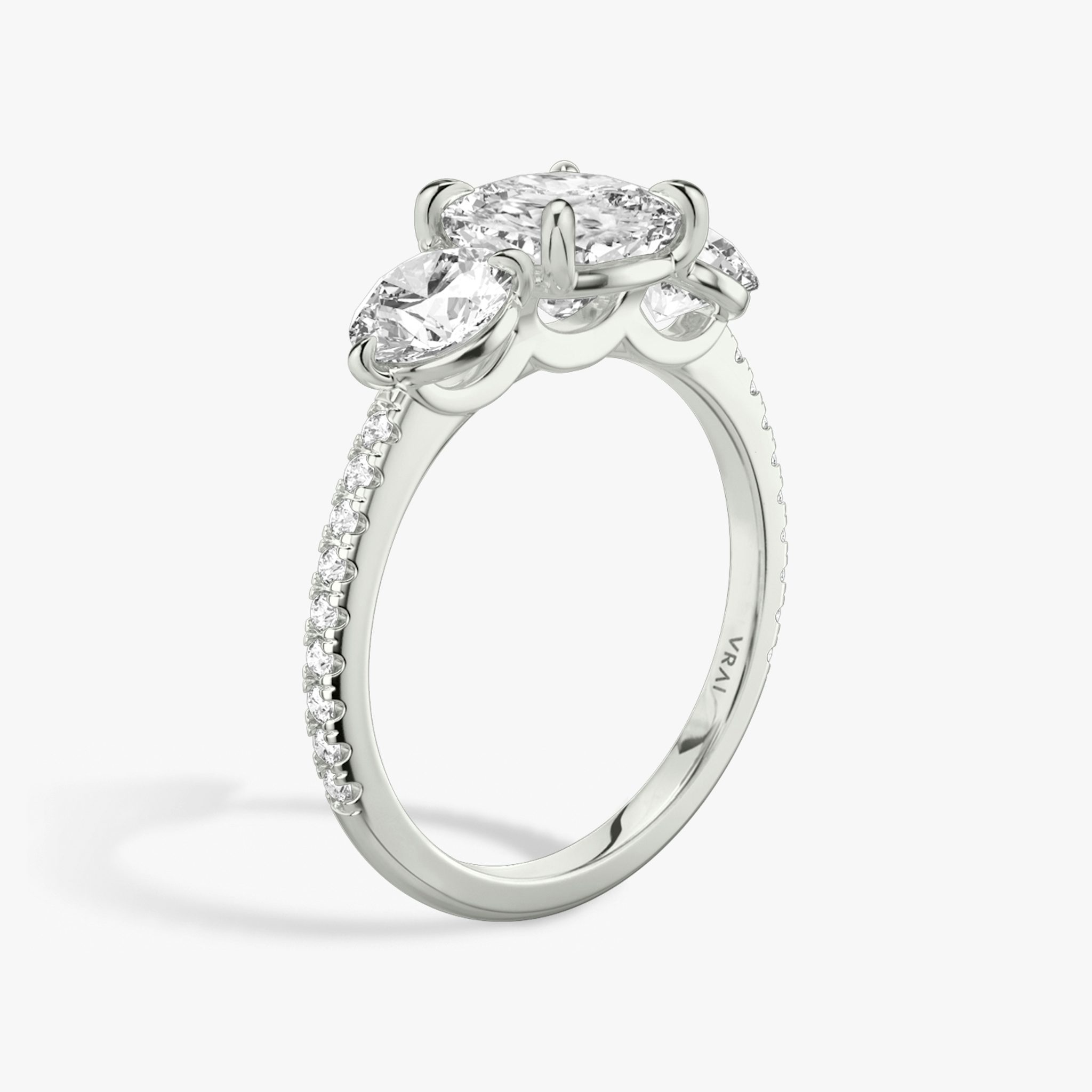 The Three Stone | Cushion | 18k | White Gold | bandAccent: Pavé | sideStoneCarat: 0.50ct | sideStoneShape: Round Brilliant | diamondOrientation: vertical | caratWeight: other