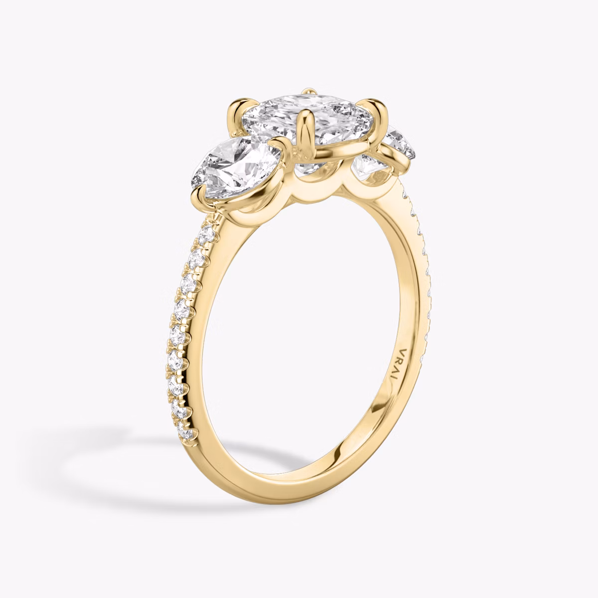 The Three Stone | Cushion | 18k | Yellow Gold | bandAccent: Pavé | sideStoneCarat: 0.50ct | sideStoneShape: Round Brilliant | diamondOrientation: vertical | caratWeight: other