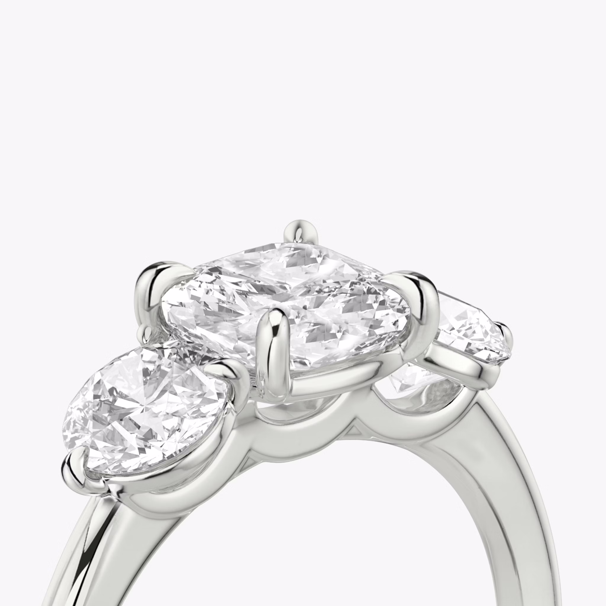 The Three Stone | Cushion | 18k | White Gold | bandAccent: Plain | sideStoneCarat: 0.50ct | sideStoneShape: Round Brilliant | diamondOrientation: vertical | caratWeight: other
