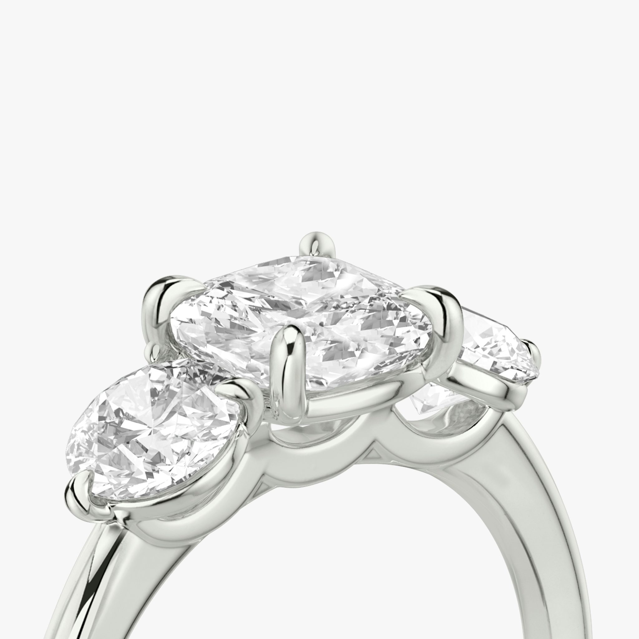 The Three Stone | Cushion | 18k | White Gold | bandAccent: Plain | sideStoneCarat: 0.50ct | sideStoneShape: Round Brilliant | diamondOrientation: vertical | caratWeight: other