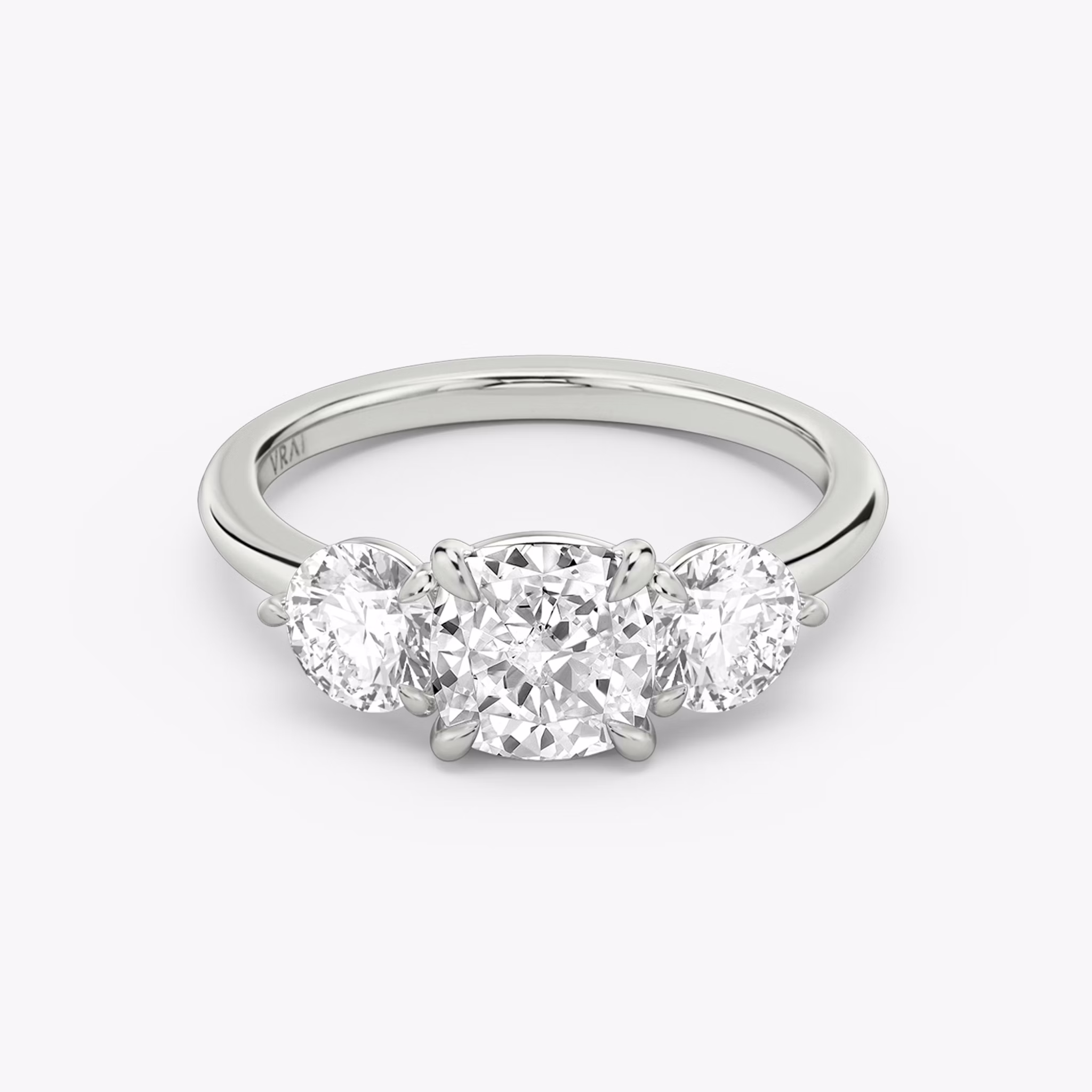 The Three Stone | Cushion | 18k | White Gold | bandAccent: Plain | sideStoneCarat: 0.50ct | sideStoneShape: Round Brilliant | diamondOrientation: vertical | caratWeight: other