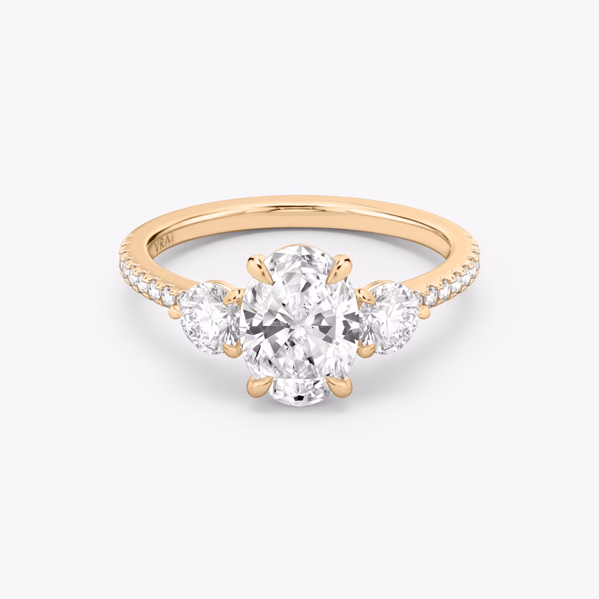 The Three Stone | Oval | 14k | Rose Gold | bandAccent: Pavé | sideStoneCarat: 0.25ct | sideStoneShape: Round Brilliant | diamondOrientation: vertical | caratWeight: other