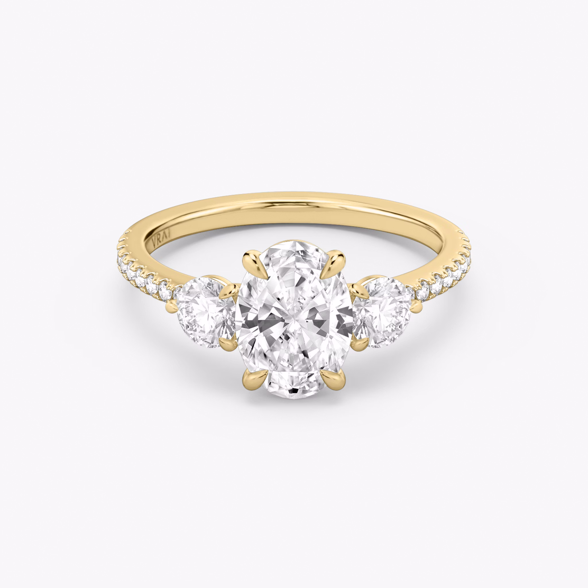 The Three Stone | Oval | 18k | Yellow Gold | bandAccent: Pavé | sideStoneCarat: 0.25ct | sideStoneShape: Round Brilliant | diamondOrientation: vertical | caratWeight: other