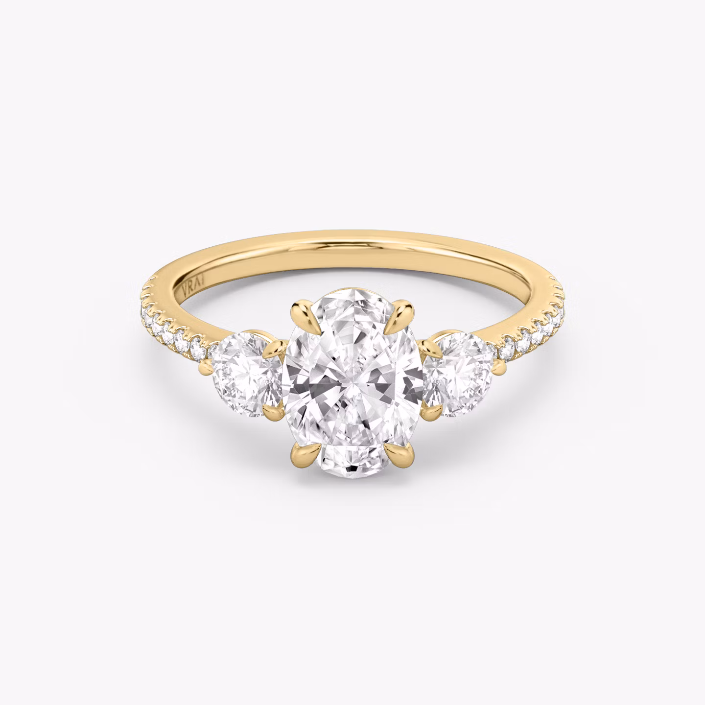 The Three Stone | Oval | 18k | Yellow Gold | bandAccent: Pavé | sideStoneCarat: 0.25ct | sideStoneShape: Round Brilliant | diamondOrientation: vertical | caratWeight: other